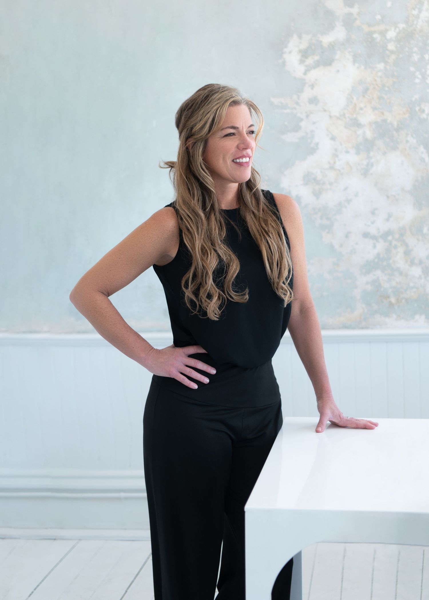 Series of elegant poses in black outfit against light background.