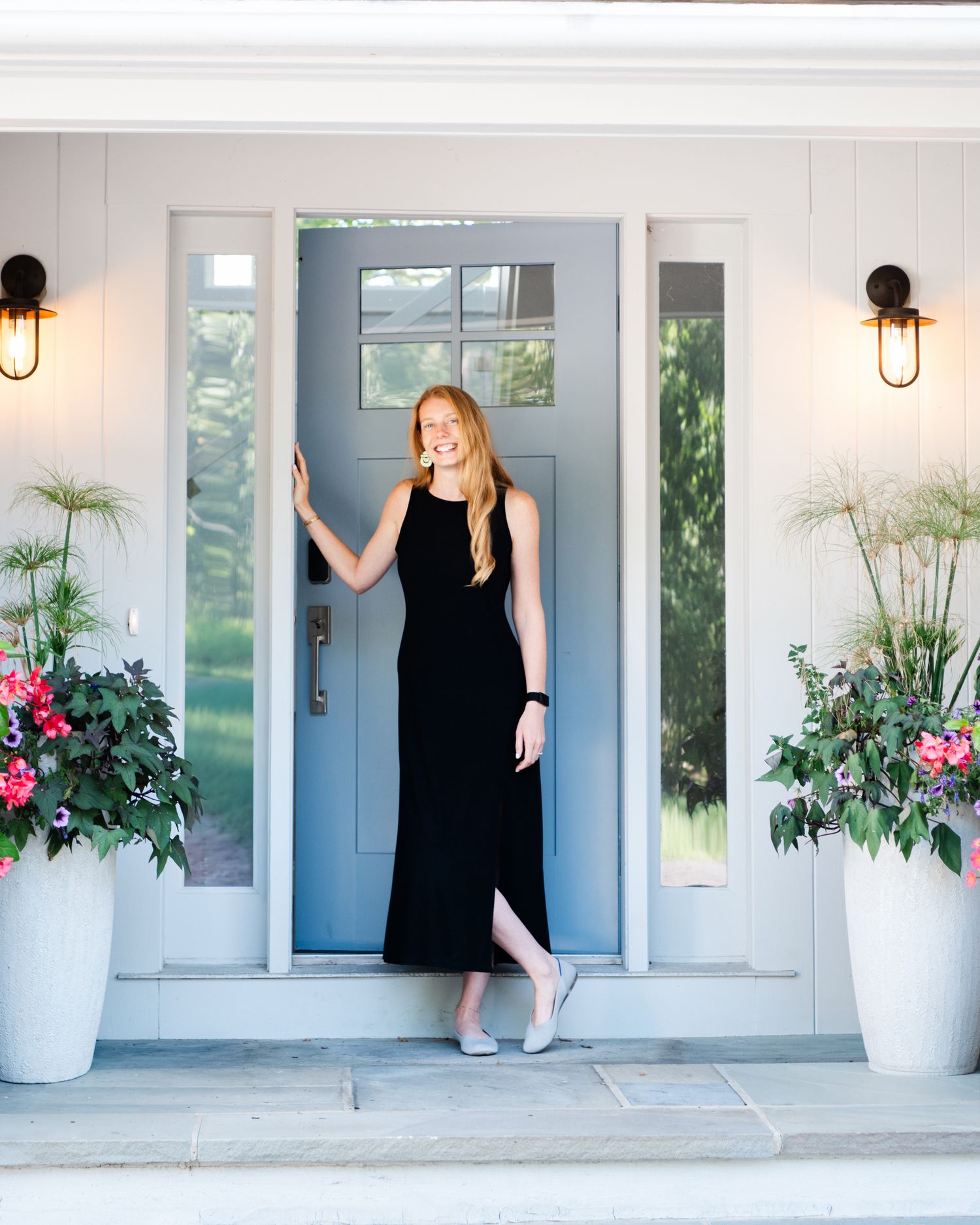 A series of photos showing a person in a black dress moving across a white porch with decorative planters and sconces in Kittery ME.