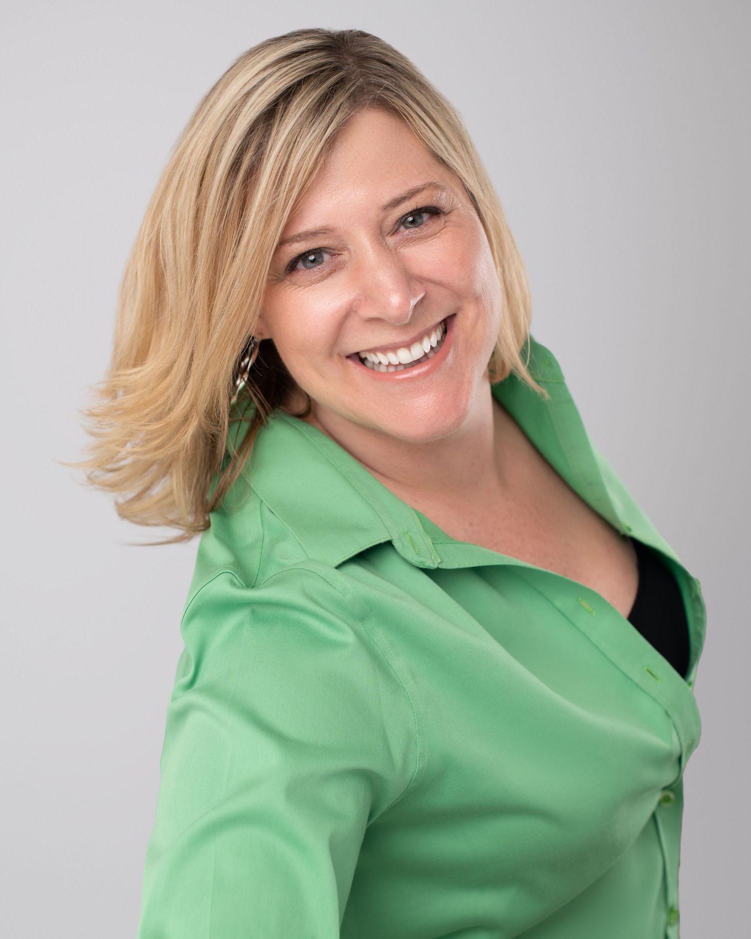Person in bright green button-down shirt smiling and posing in sequence of casual portrait photos against gray background.