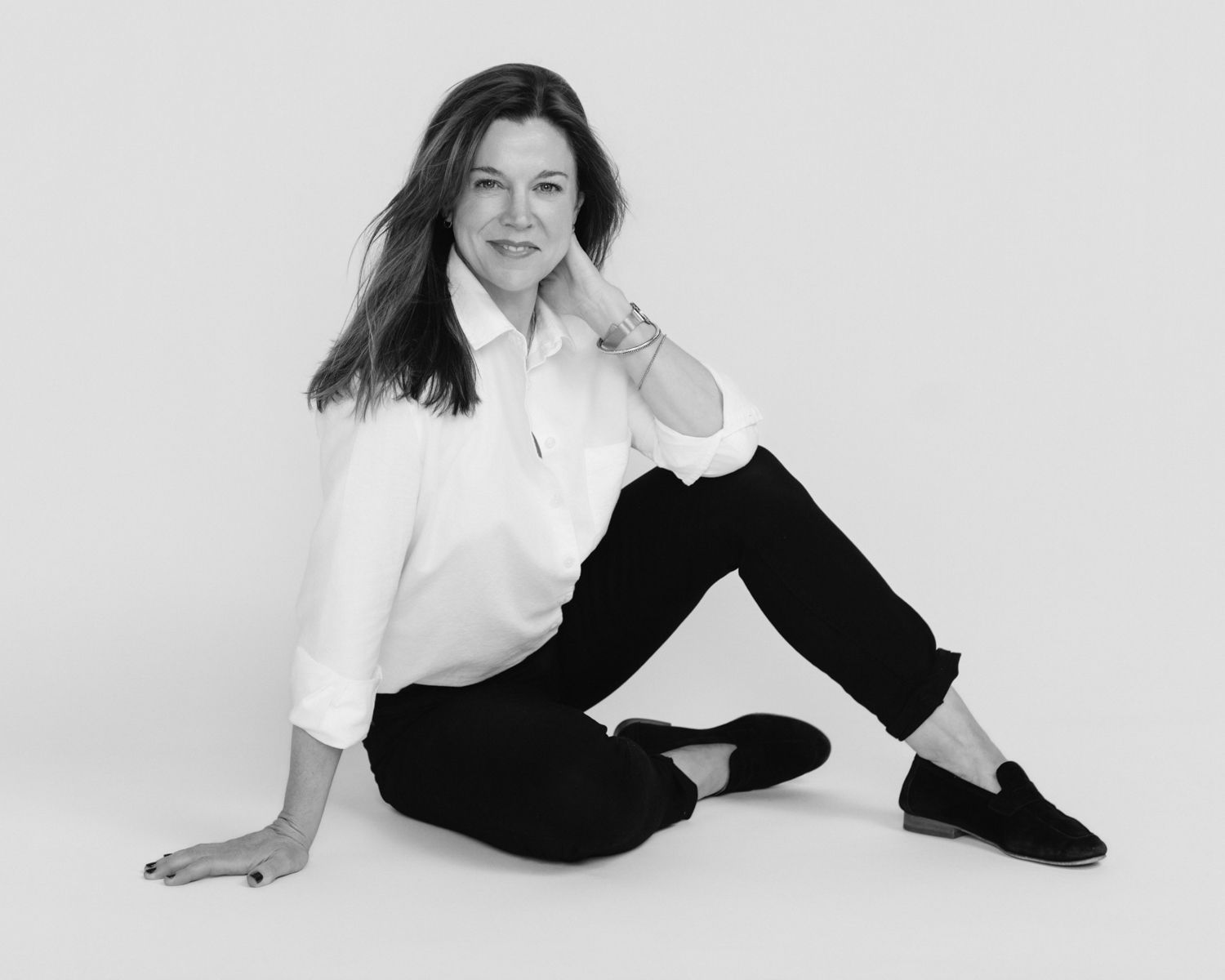 Artistic black and white portraits showing relaxed poses in monochrome outfit.