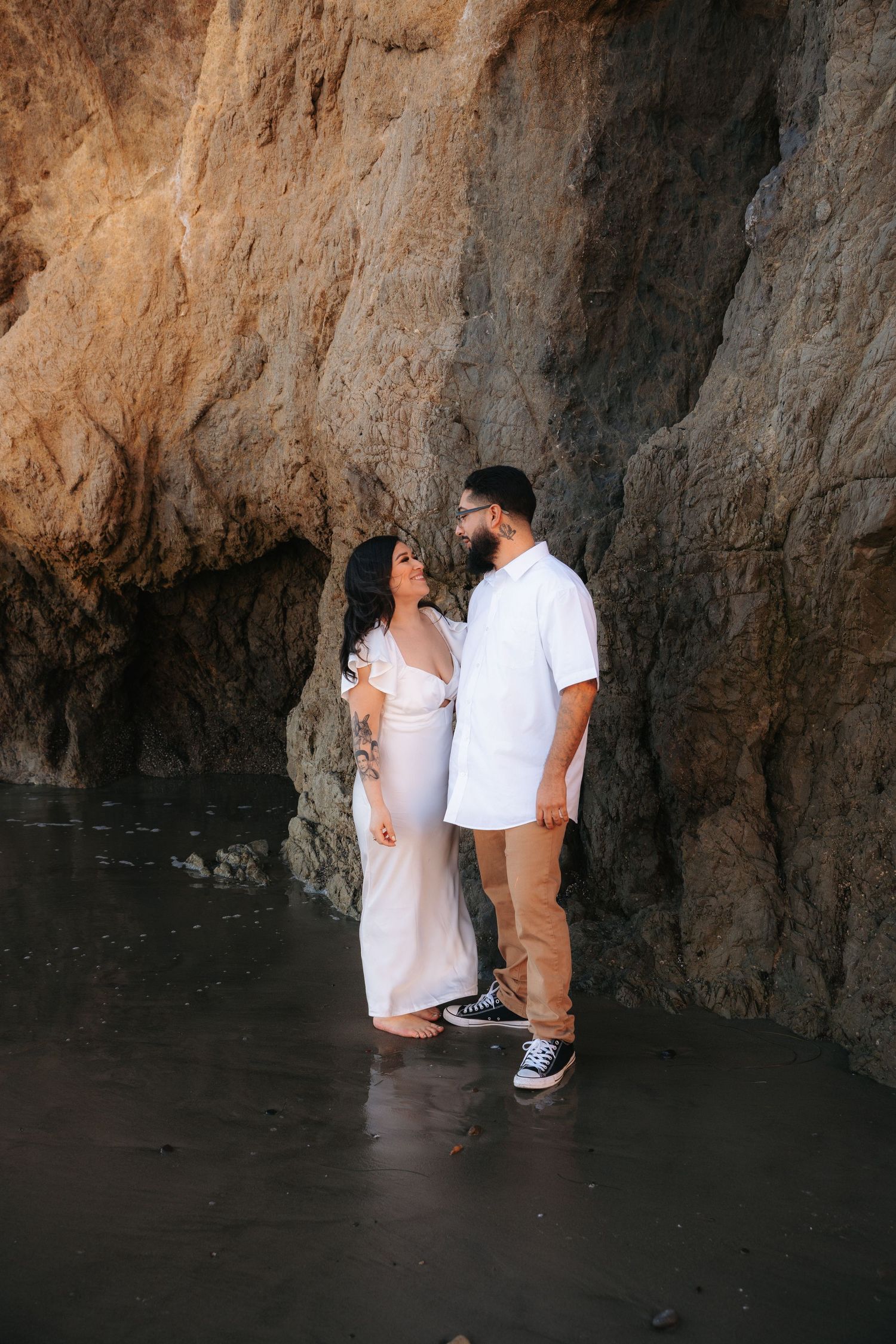 Couple at the beach falling in love through their eye contact, a cinematic, intimate, and natural moment.