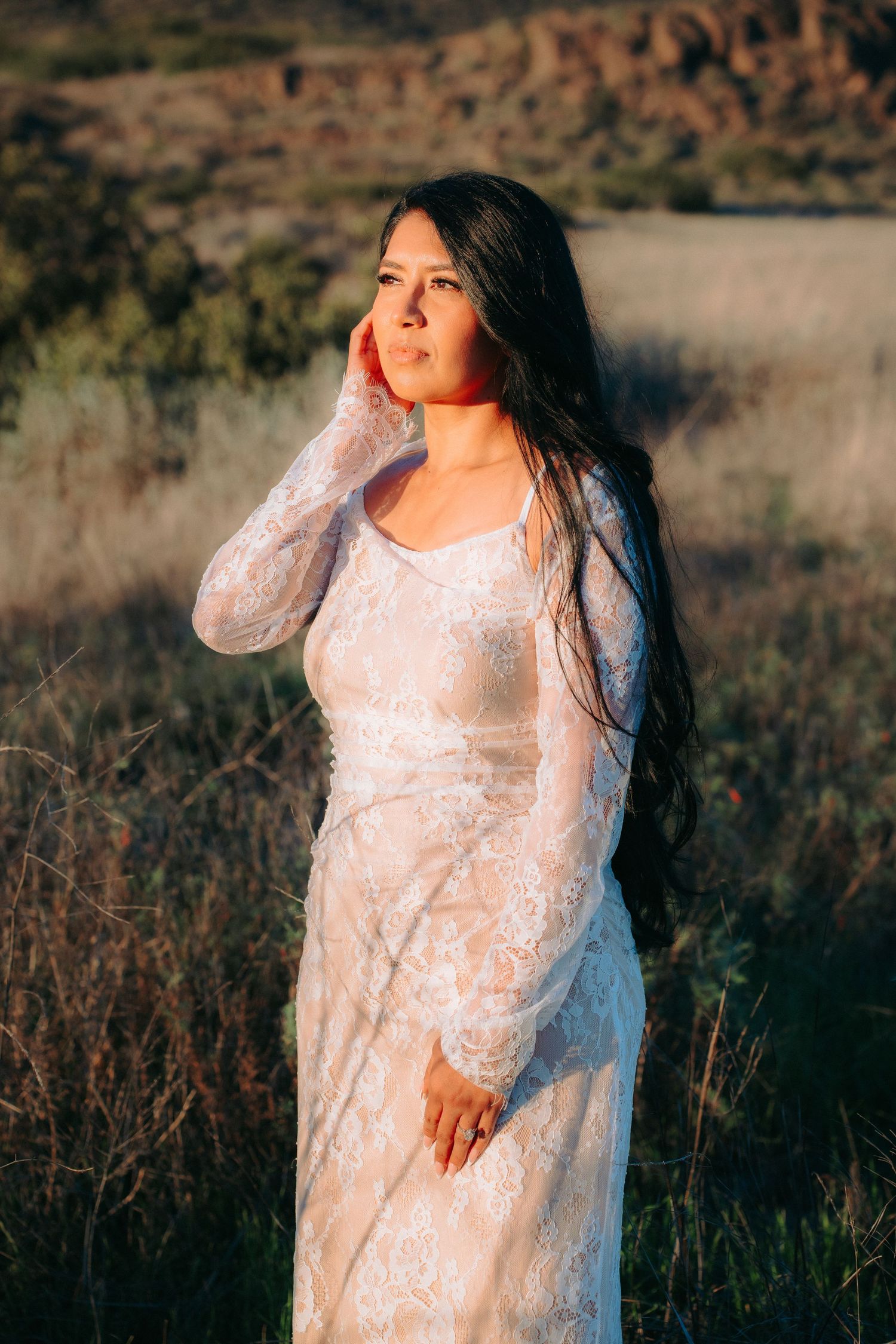Portrait of the bride looking into golden hour light, captured in a timeless, cinematic, and romantic moment.