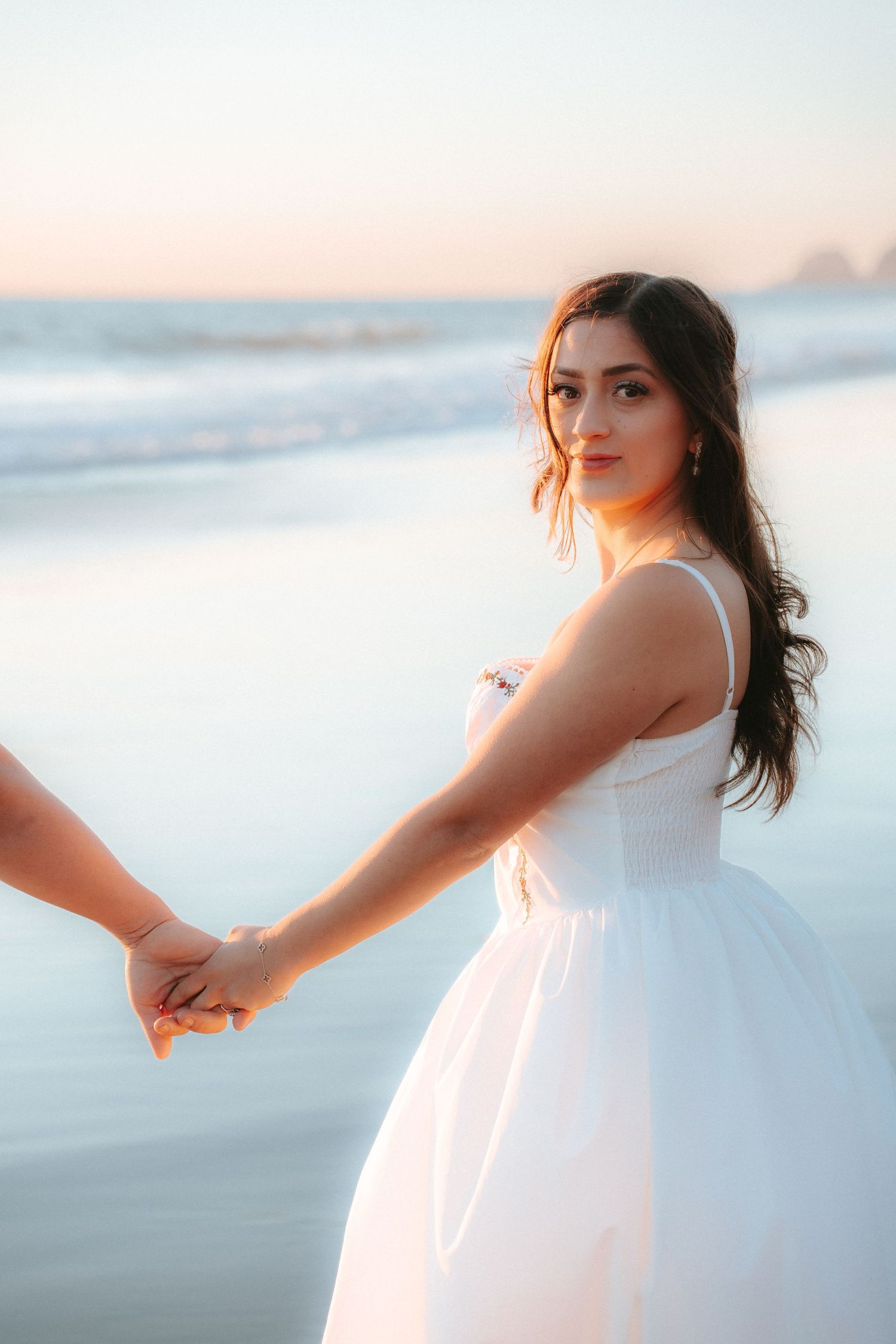 Portrait of the bride on the beach during sunset, showcasing natural elegance, in-the-moment storytelling, and cinematic style.