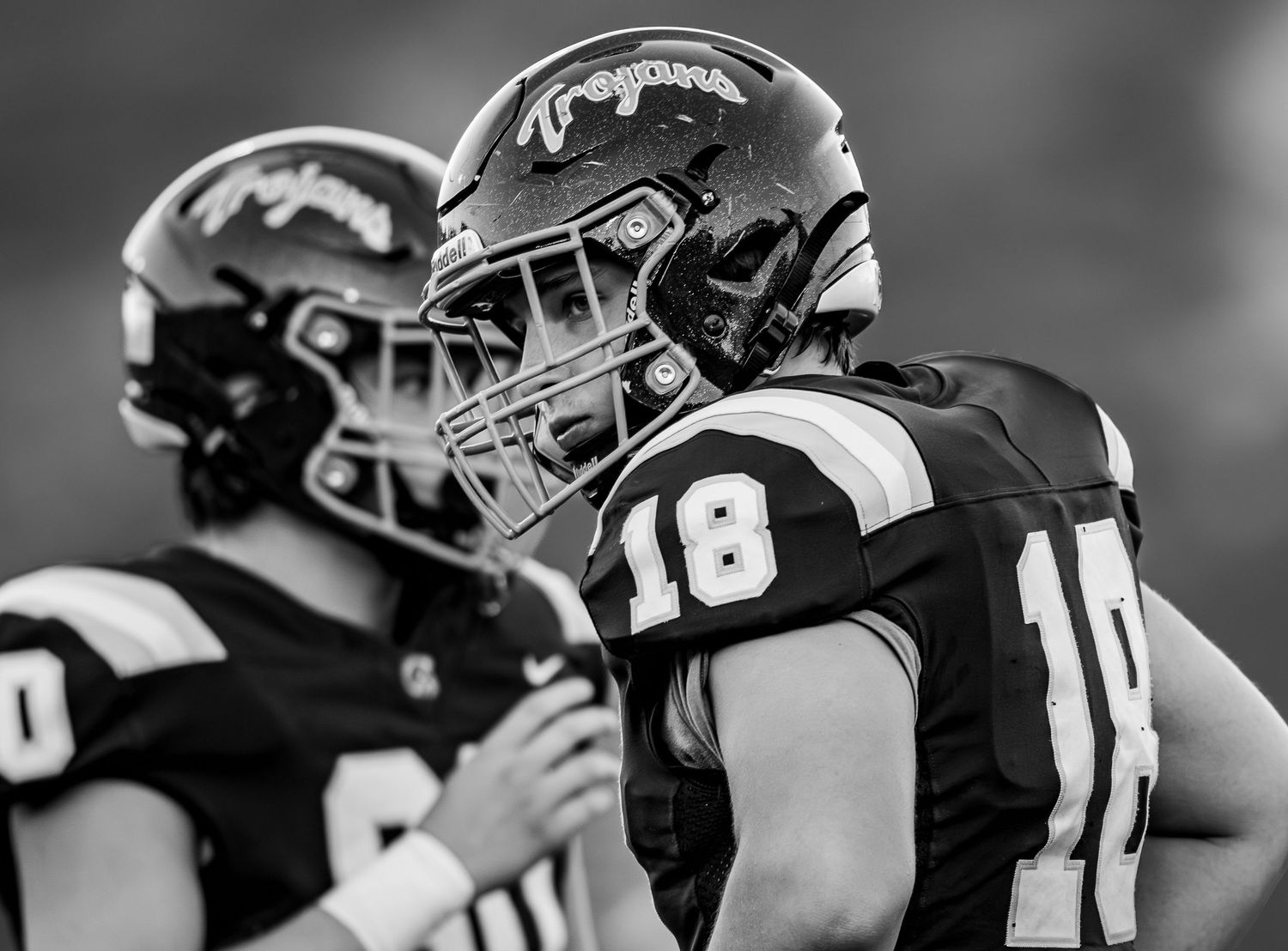 Football players in black and white uniforms lined up during a game.