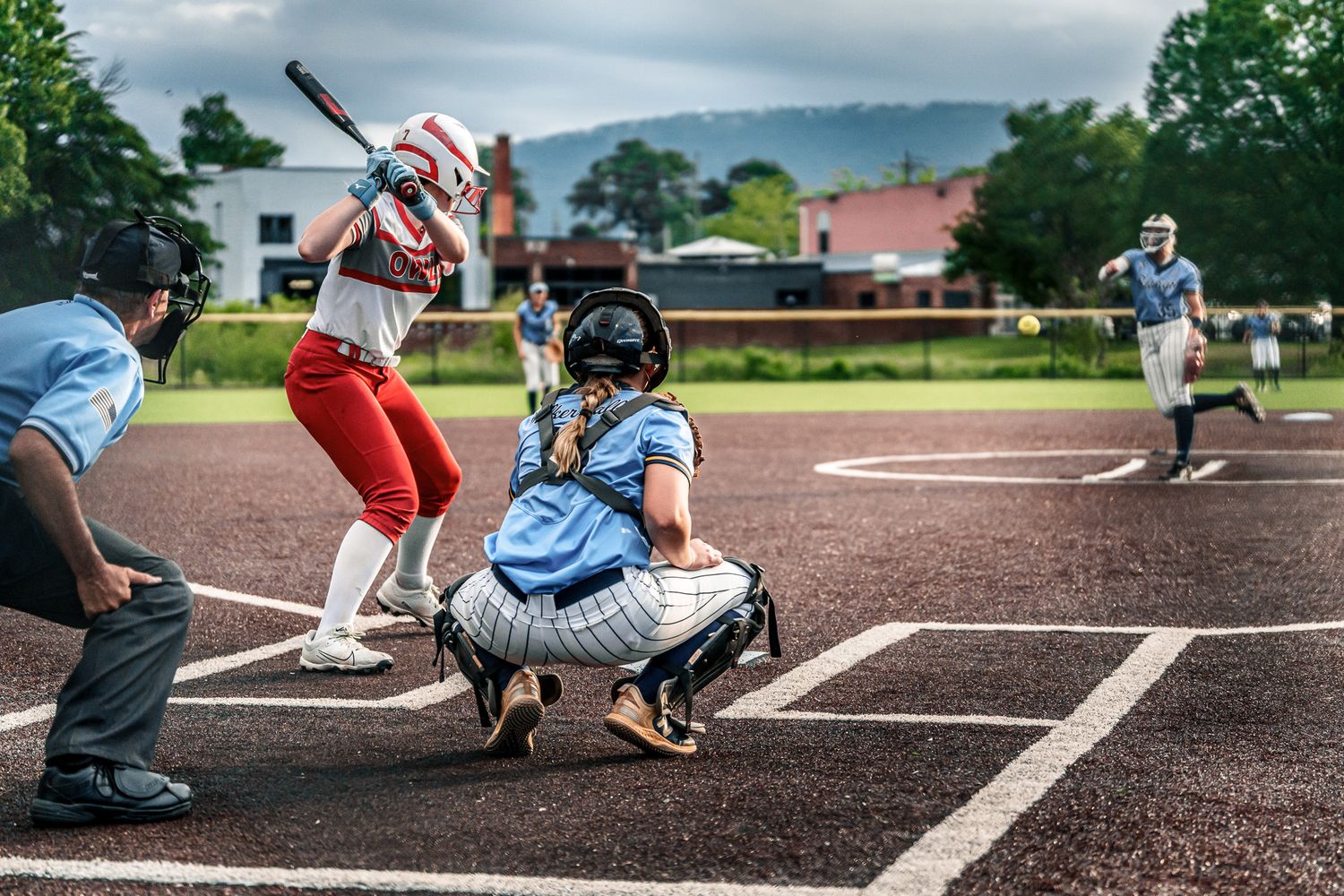 Baseball players in action during a game, showing close-up shots of batting and catching plays.