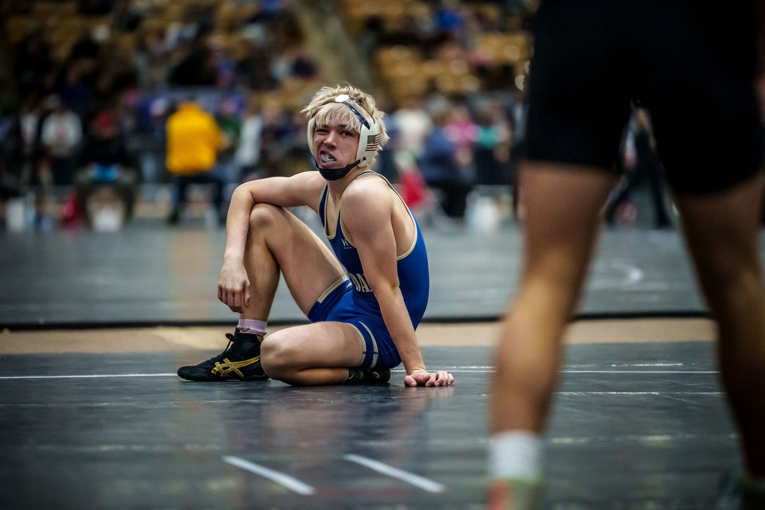 Close-up of wrestlers competing on the mat during a match.