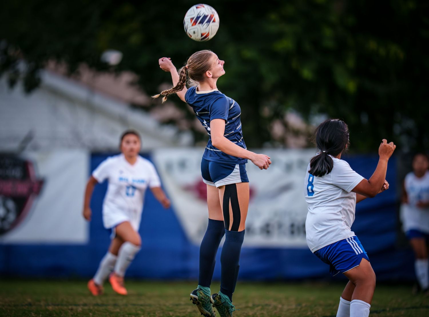 Soccer players competing for control of the ball during an intense match.