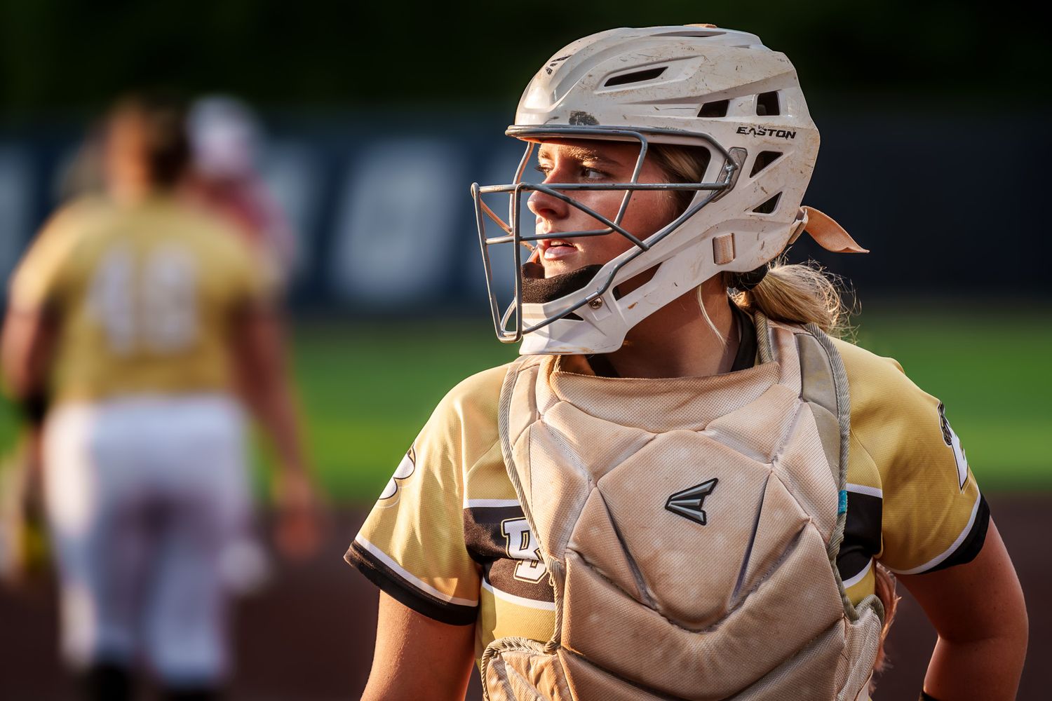 Baseball catchers in protective gear lined up during a game or practice.