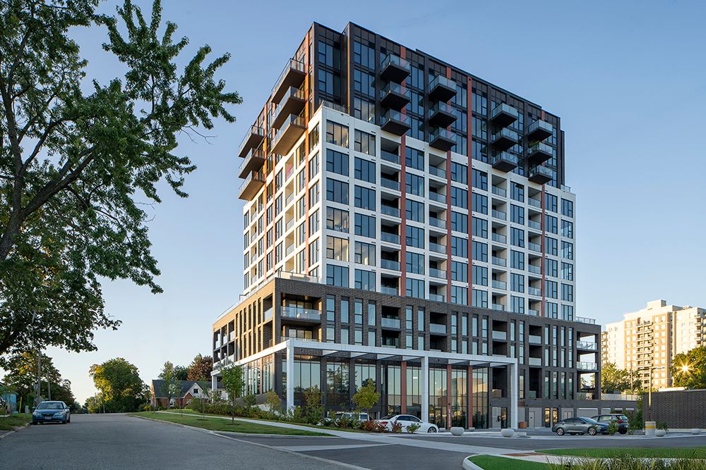 Modern multi-story apartment building with glass balconies and wood accents shown from multiple exterior angles.