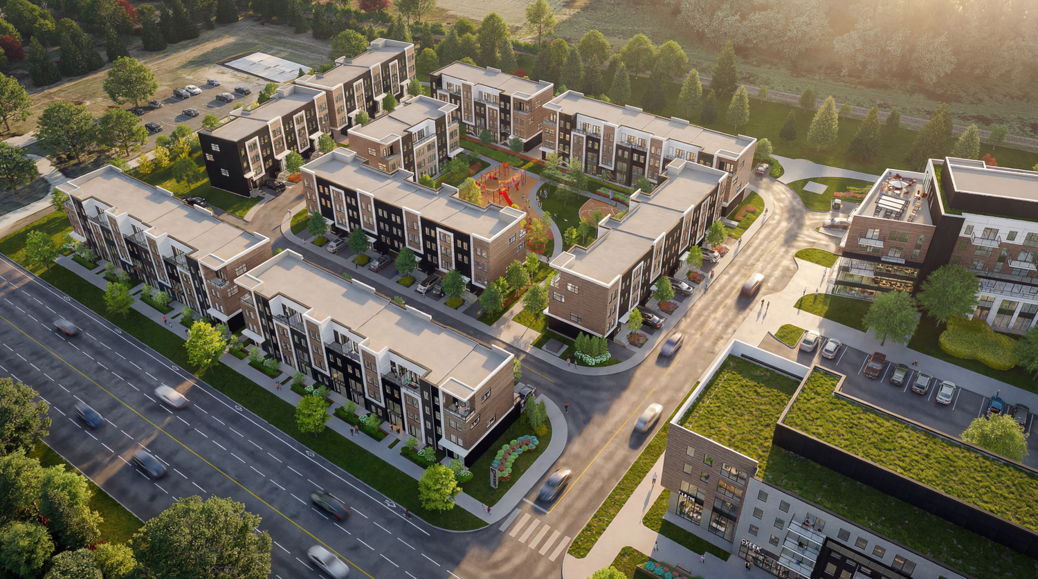 Aerial view of modern apartment complex with landscaped grounds and parking areas in a residential development.