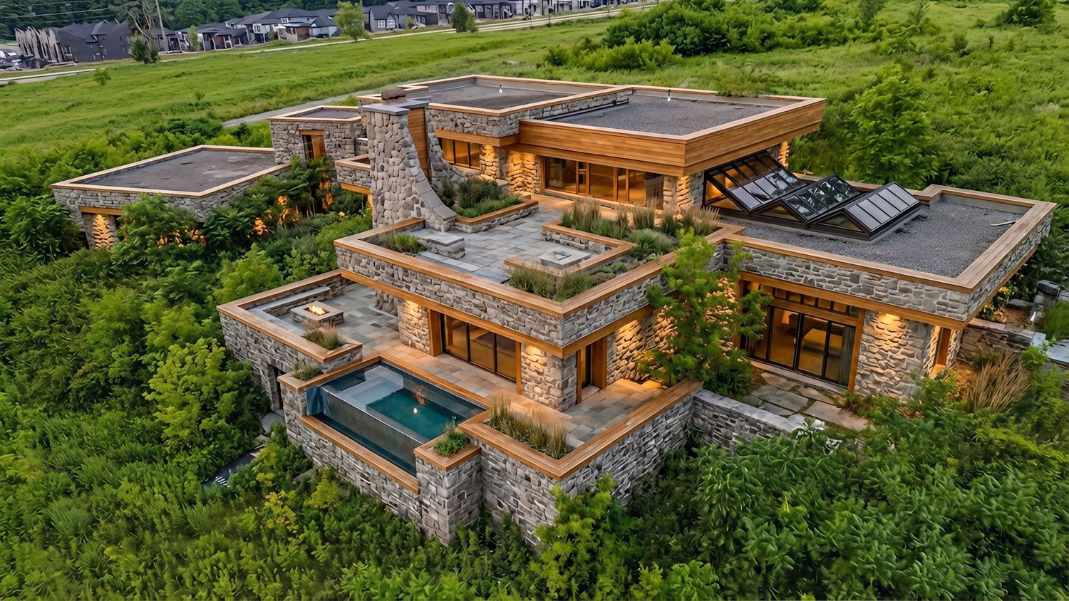 Luxury modern hillside home with multiple levels, green roofs, stone walls, and an infinity pool overlooking scenic landscape.