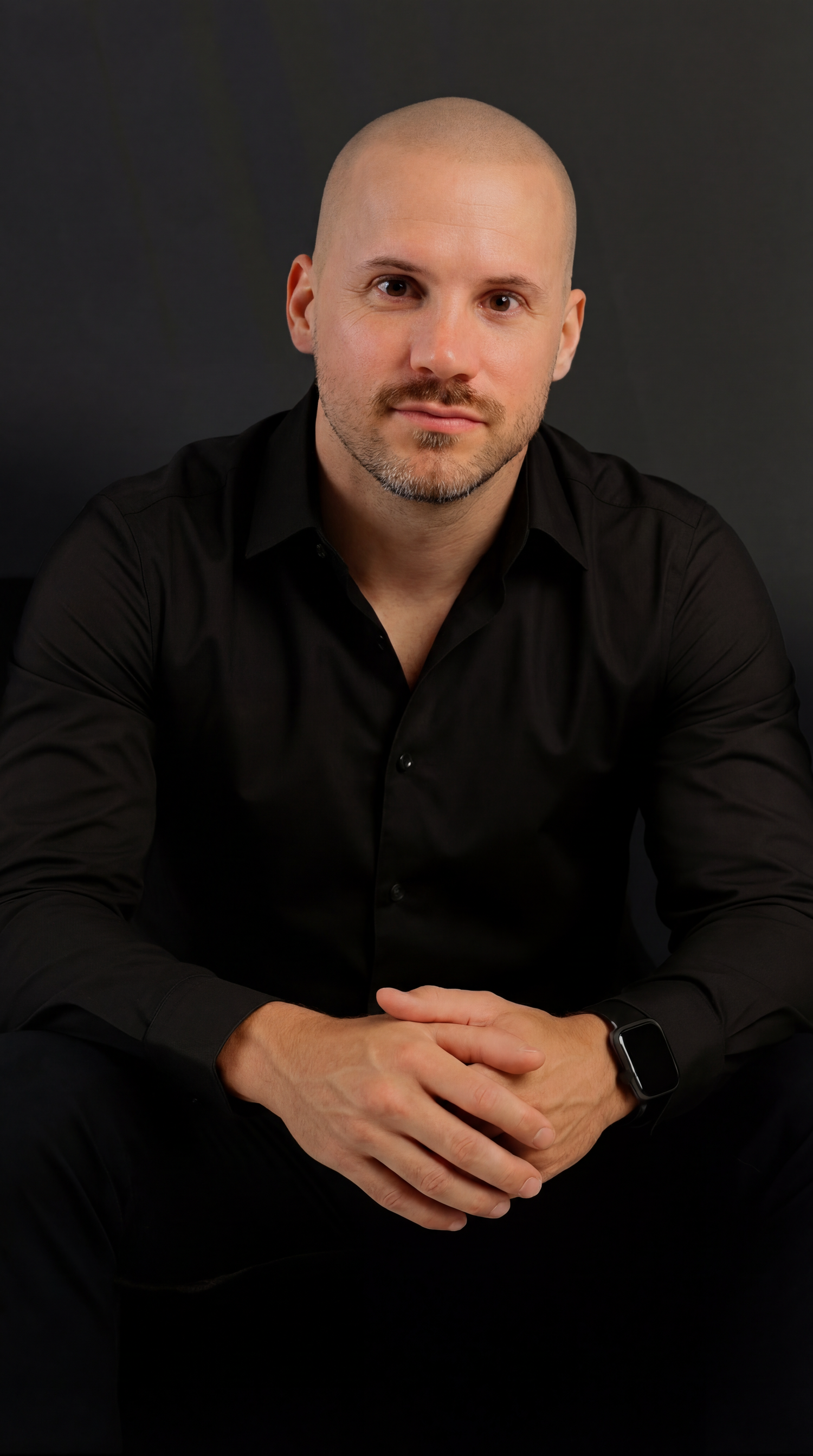 Professional headshot portrait of person in black shirt against dark background with varied poses showing different angles.