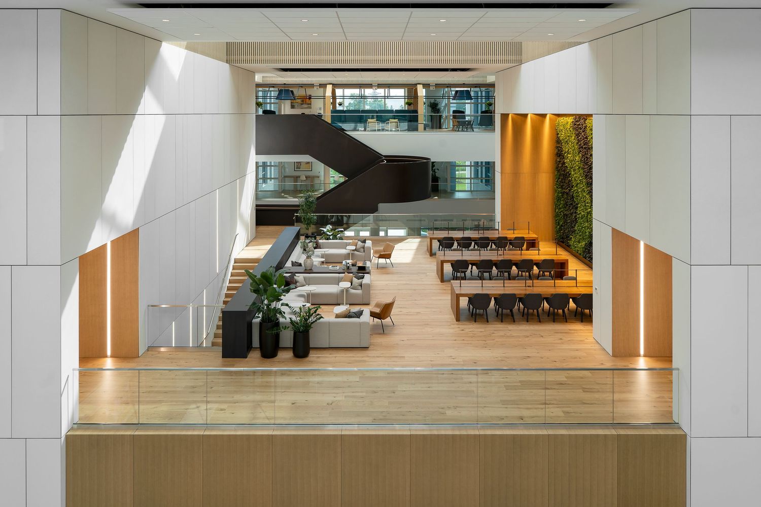 Modern office hallway with sleek white walls, recessed lighting, and polished concrete floors creating a minimalist corporate space.