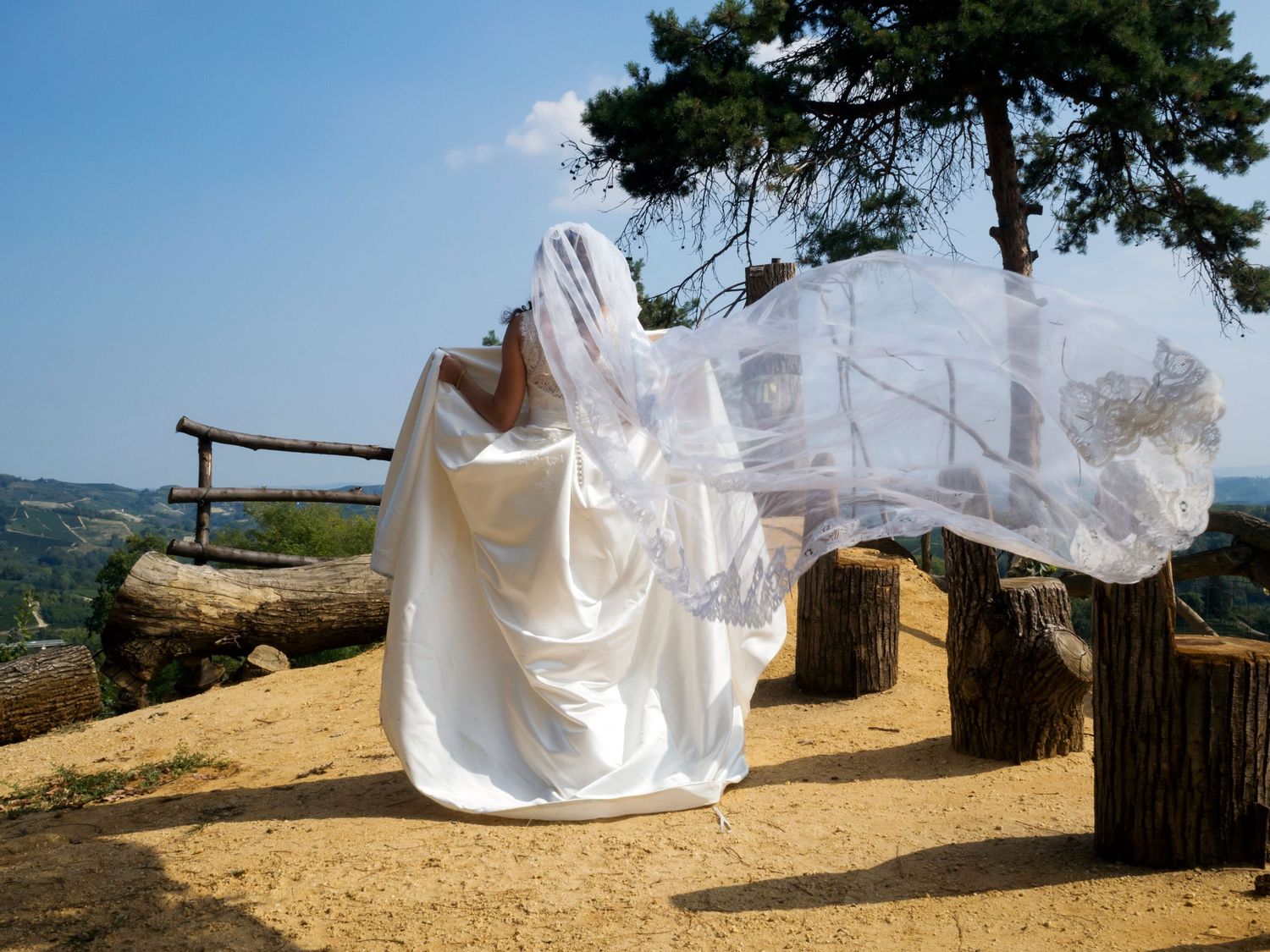 Sposa cammina con velo che vola durante un matrimonio scattato da Stefania Bosso di Weddingtelling