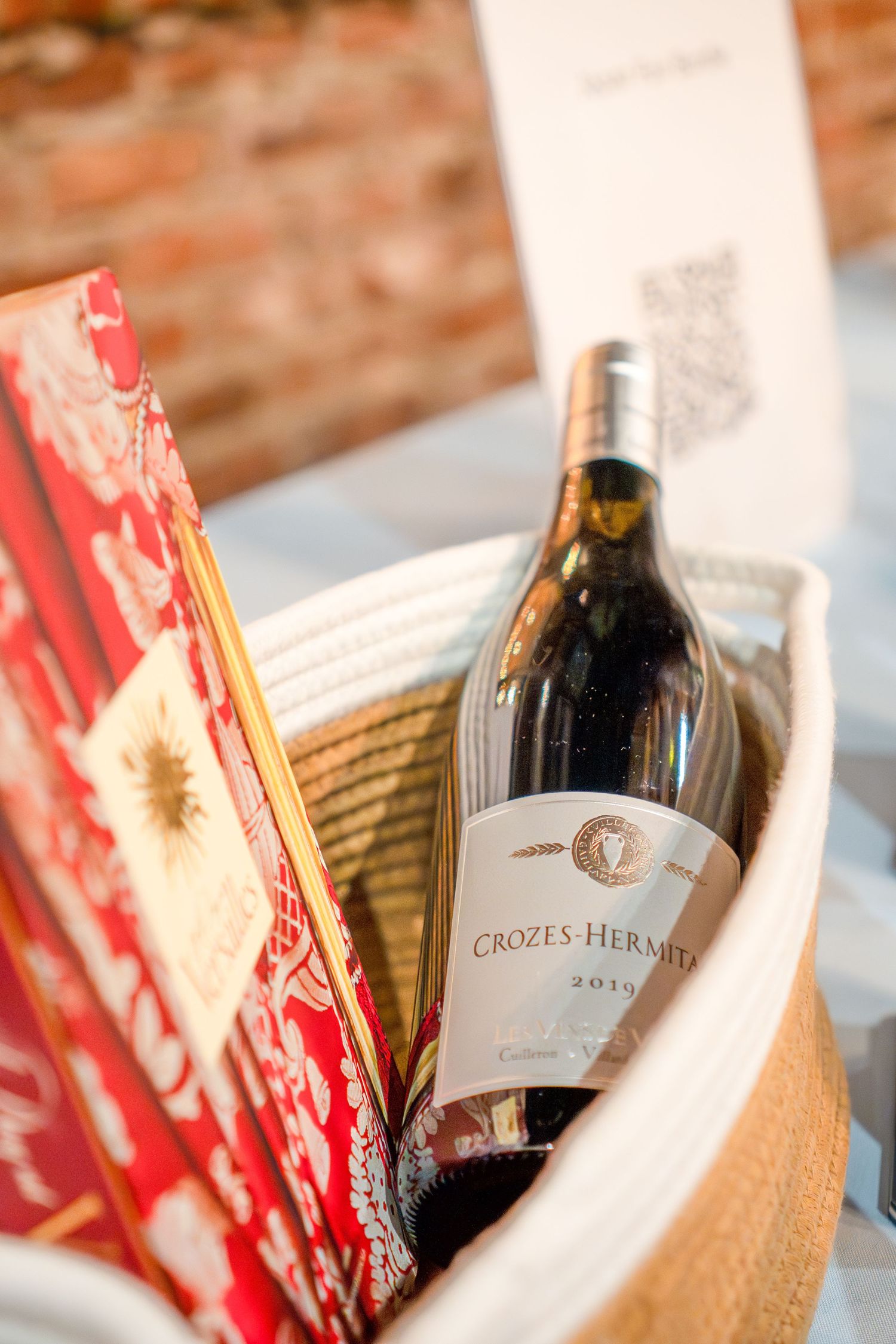 Wine bottles and red decorative elements arranged in a display setting.