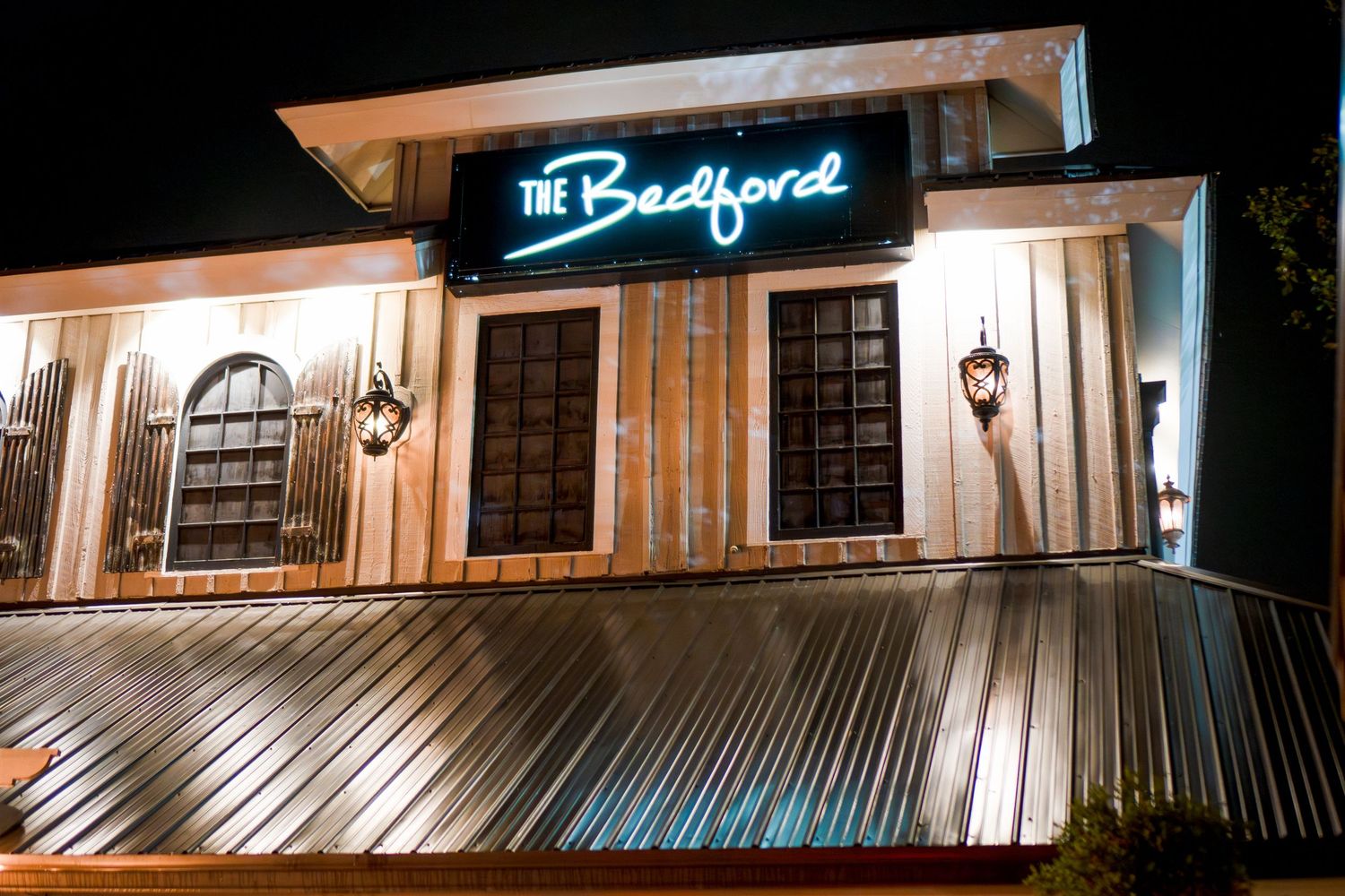 Exterior nighttime view of The Backyard venue with illuminated signage.