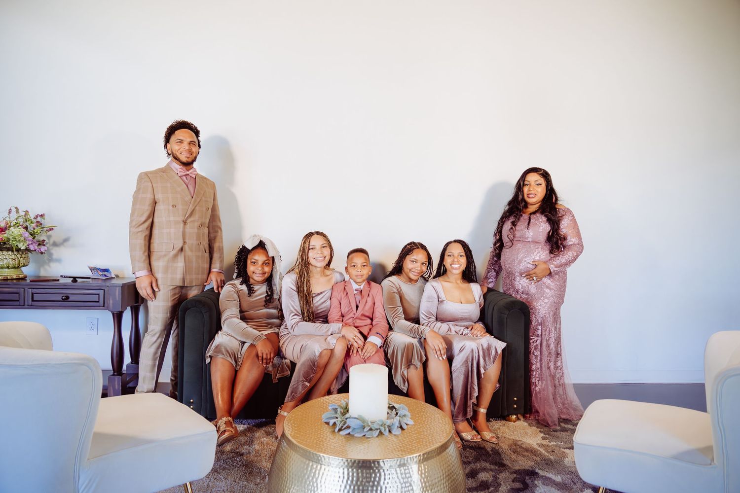 Group gathering in bright room with casual seating arrangement.