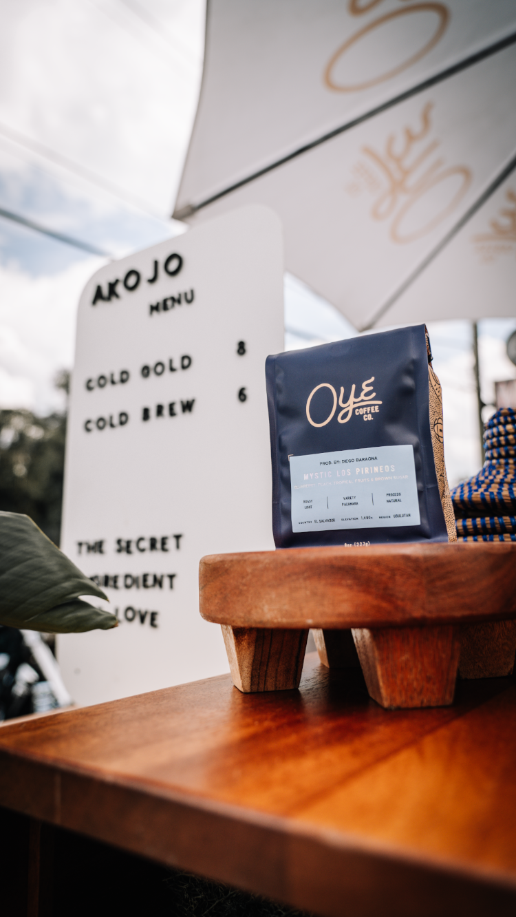 Coffee menu items displayed on wooden blocks with Oye Coffee Co branding.