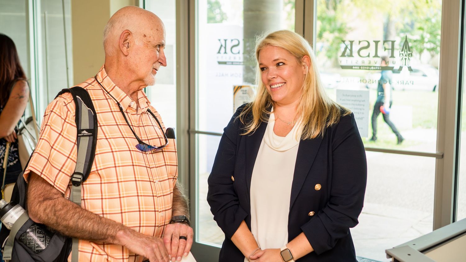 Business professionals engaged in friendly conversation during a networking event.