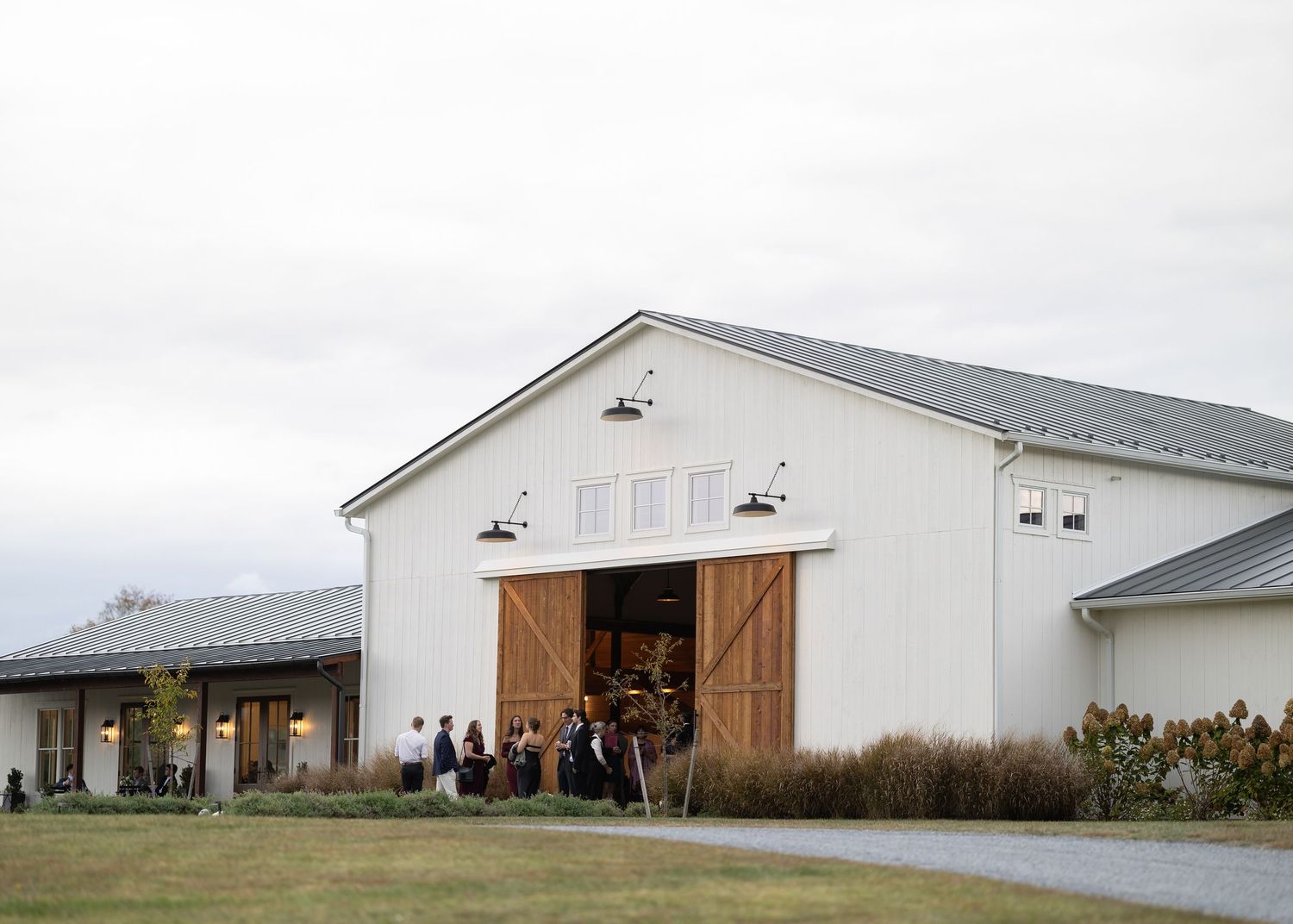 Guests enjoying cocktail hour at Tiffin Farm Barn Charlottesville VA wedding photography editorial and candid style