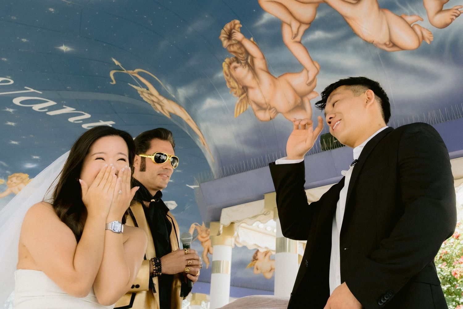 Wedding couple shares intimate moments against a blue sky backdrop at a Las Vegas chapel.