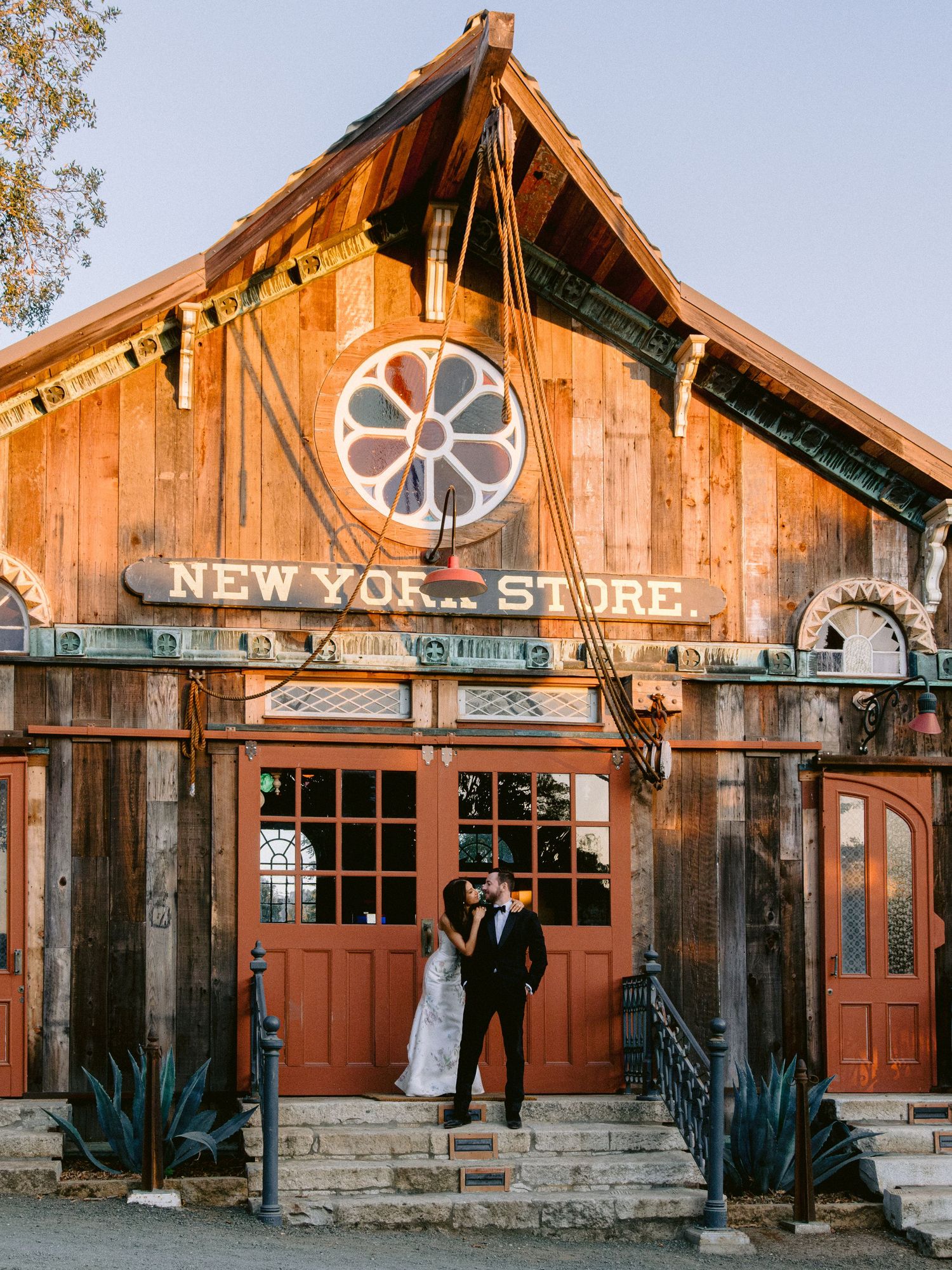 Rustic wooden New York Store building exterior with vintage charm serving as wedding venue backdrop.