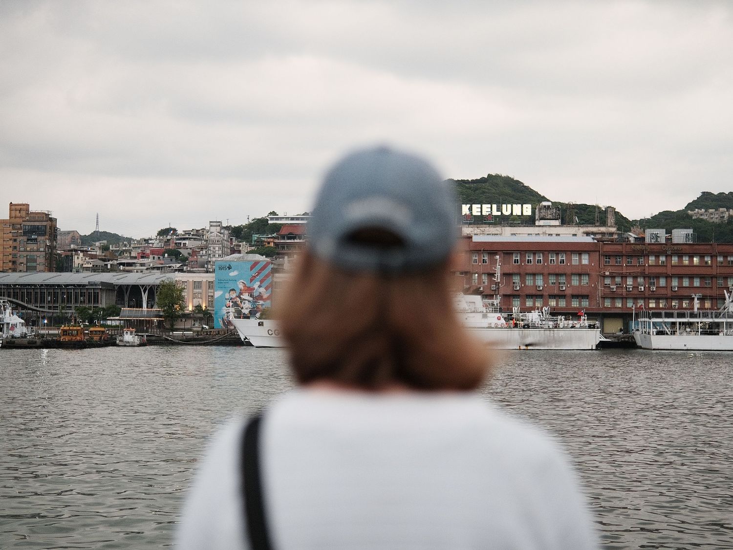 Waterfront view of a harbor town with buildings along the shoreline.
