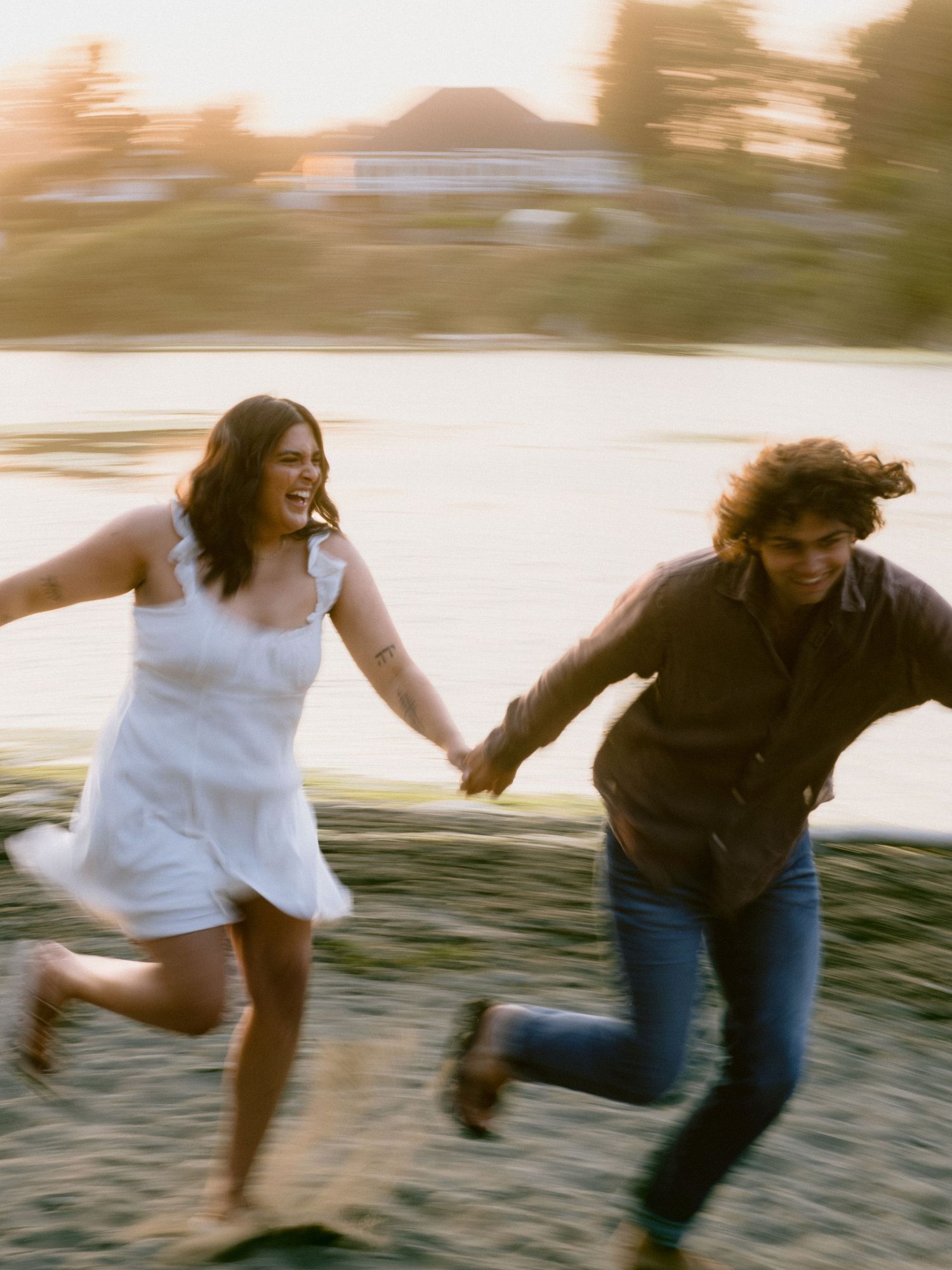 A playful sequence of two people running and jumping on a beach at sunset.