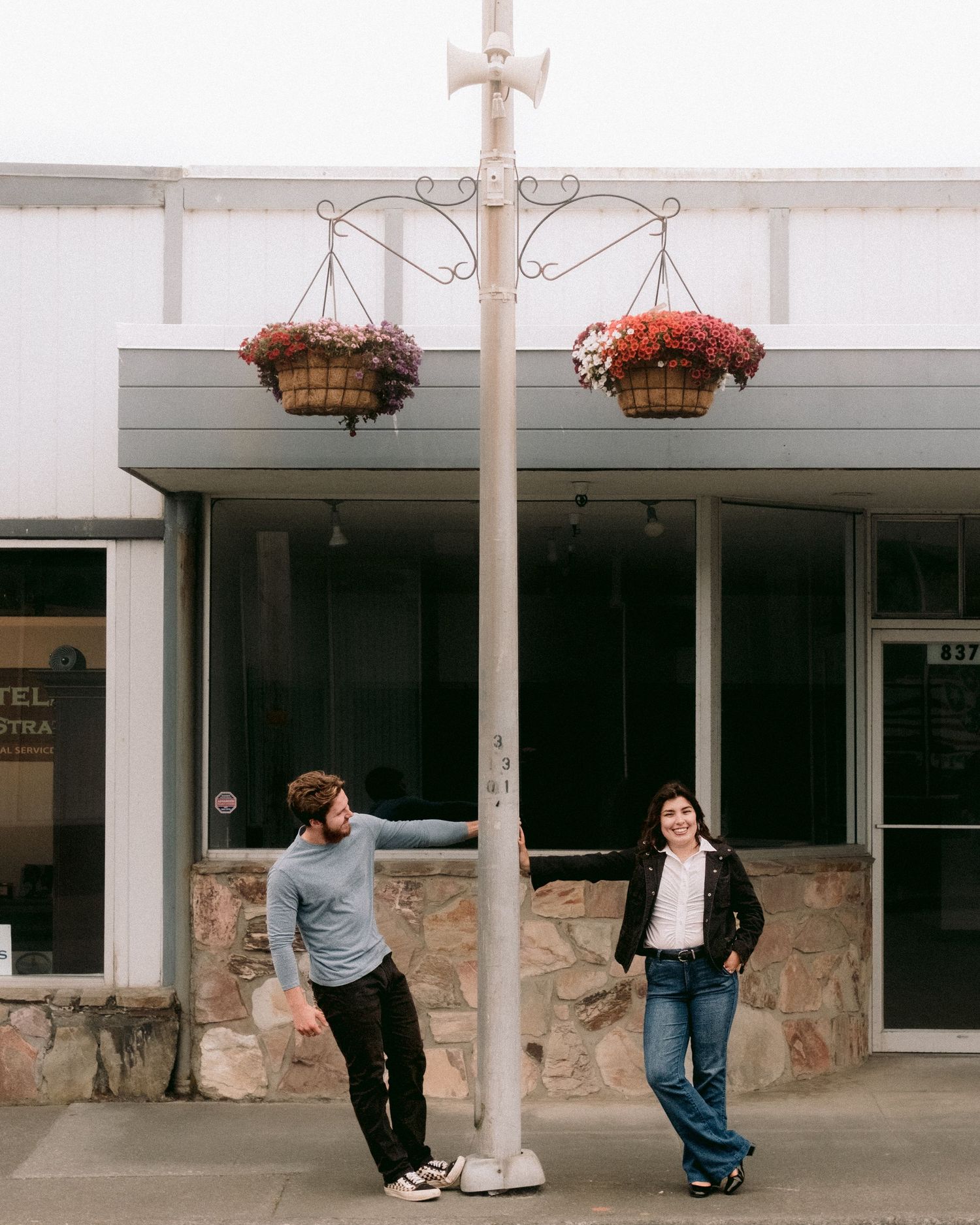 People interacting with white pillars outside a storefront in an artistic sequence.