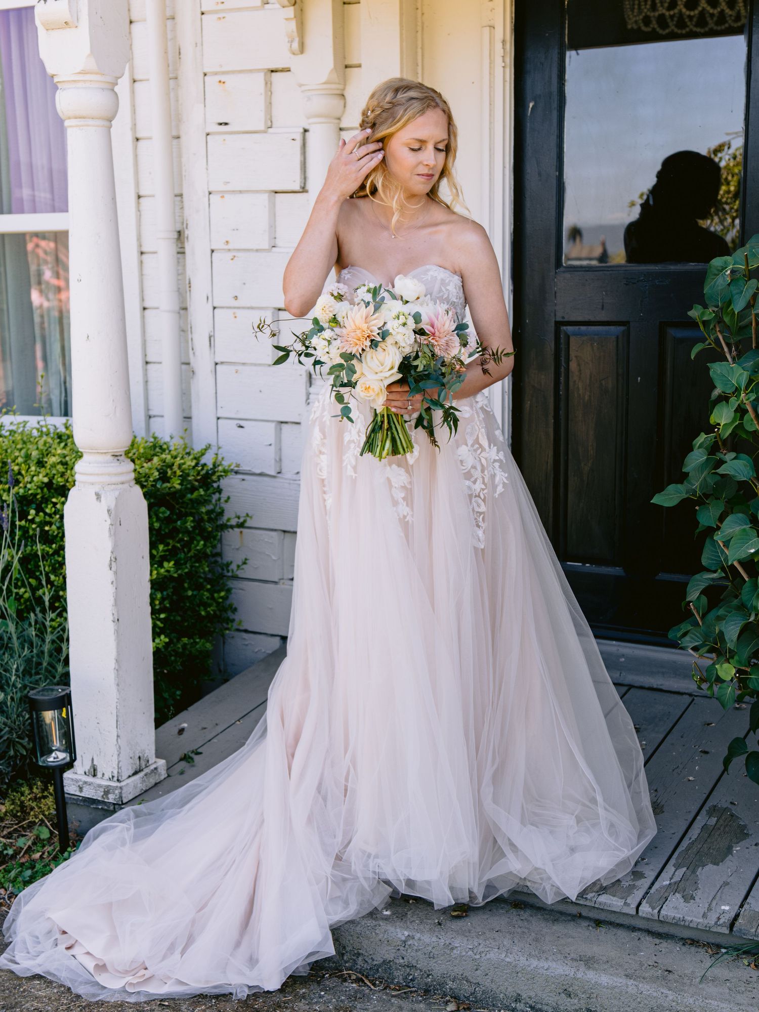 Ethereal blush wedding dress with flowing tulle skirt and floral details captured in multiple angles on a white porch.