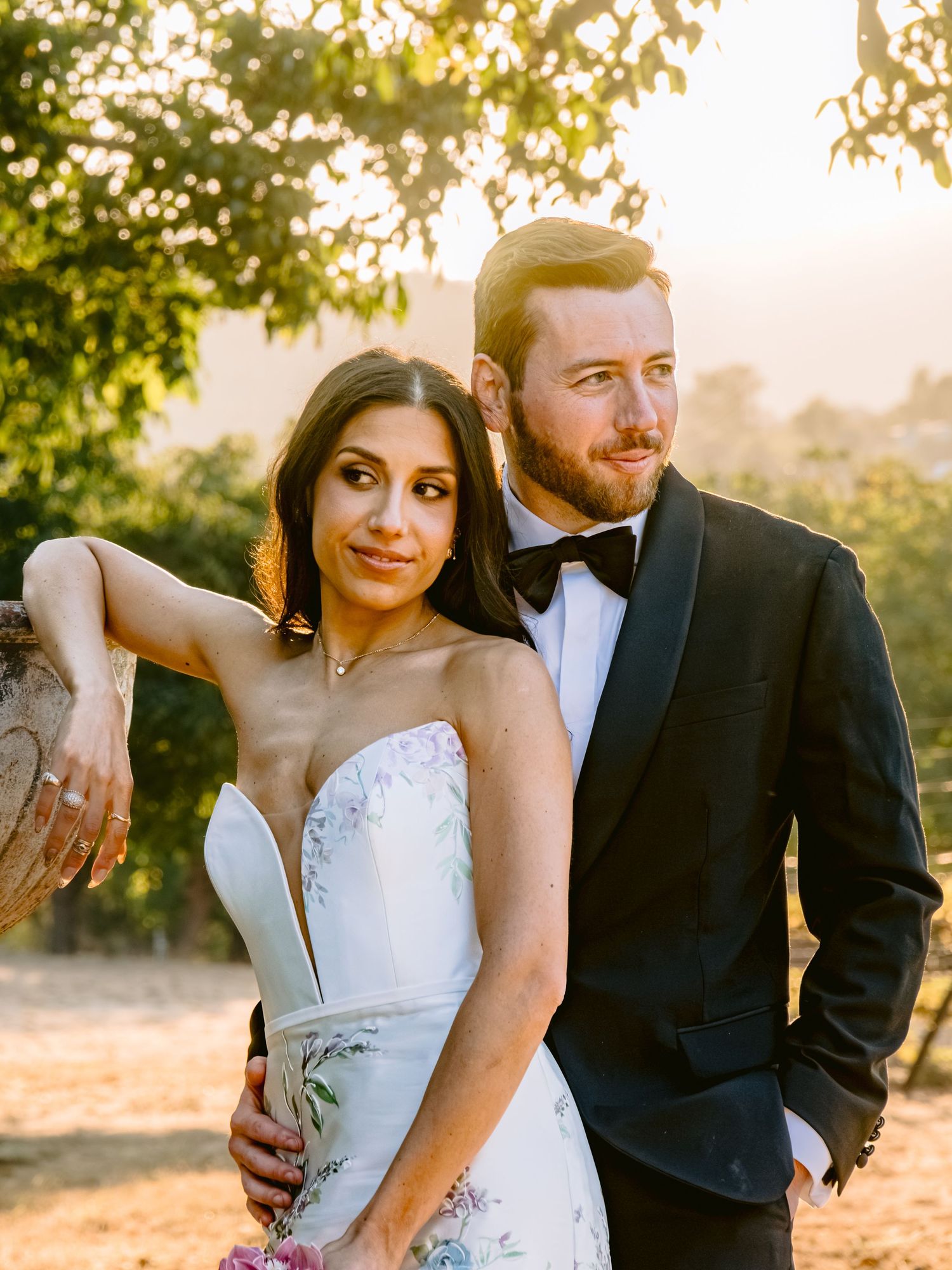 Romantic sunset wedding portraits captured in golden hour lighting.