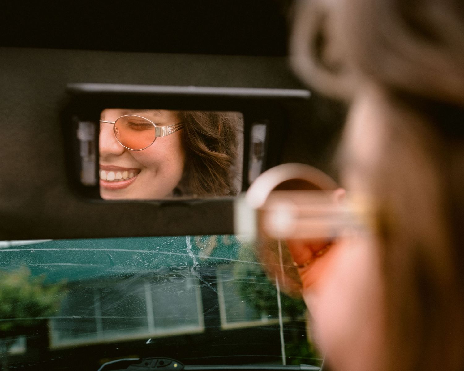 Close-up sequence showing reflections in car windows and mirrors.