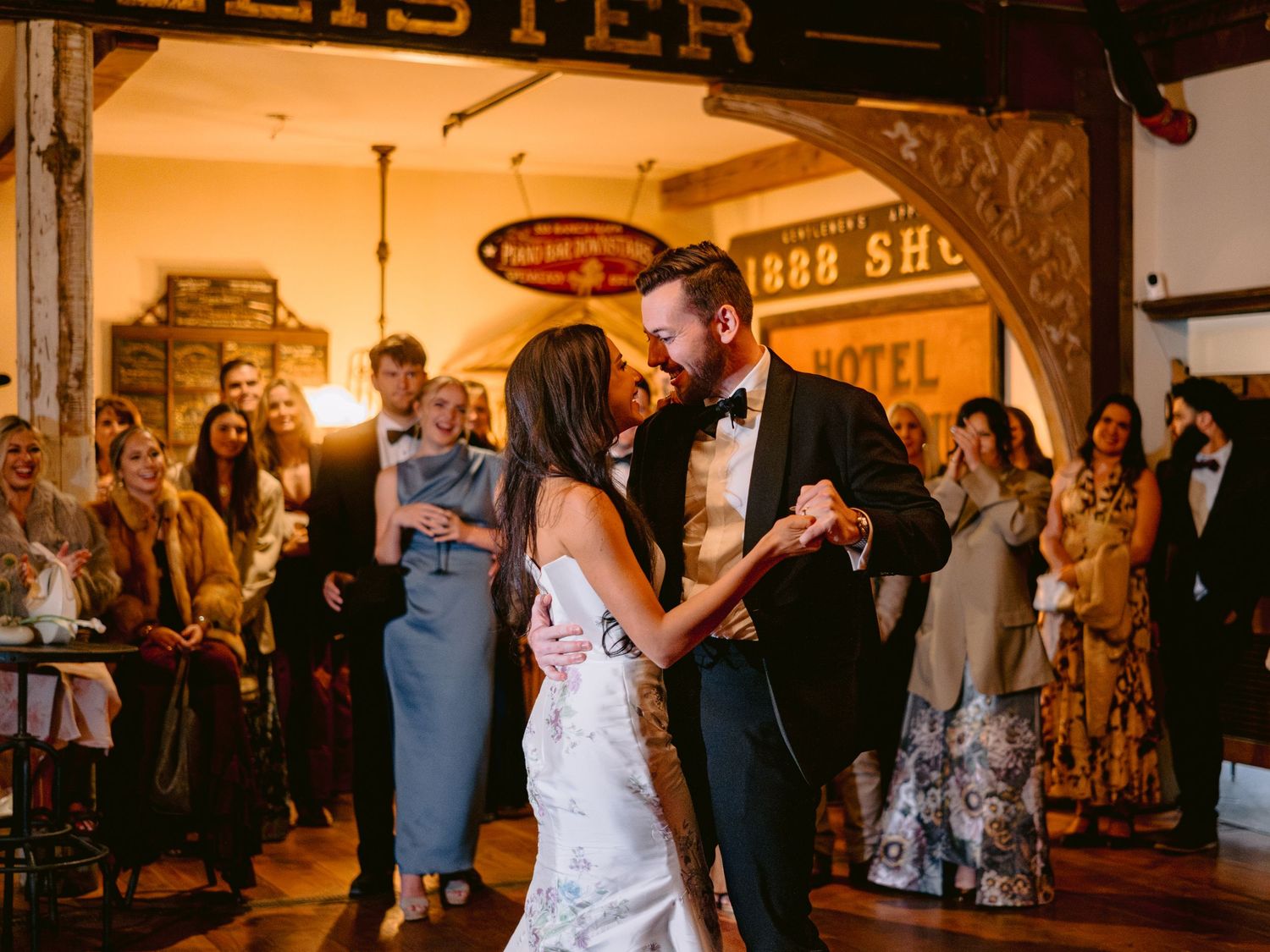 A lively wedding reception scene with dancing and celebration in a rustic venue.