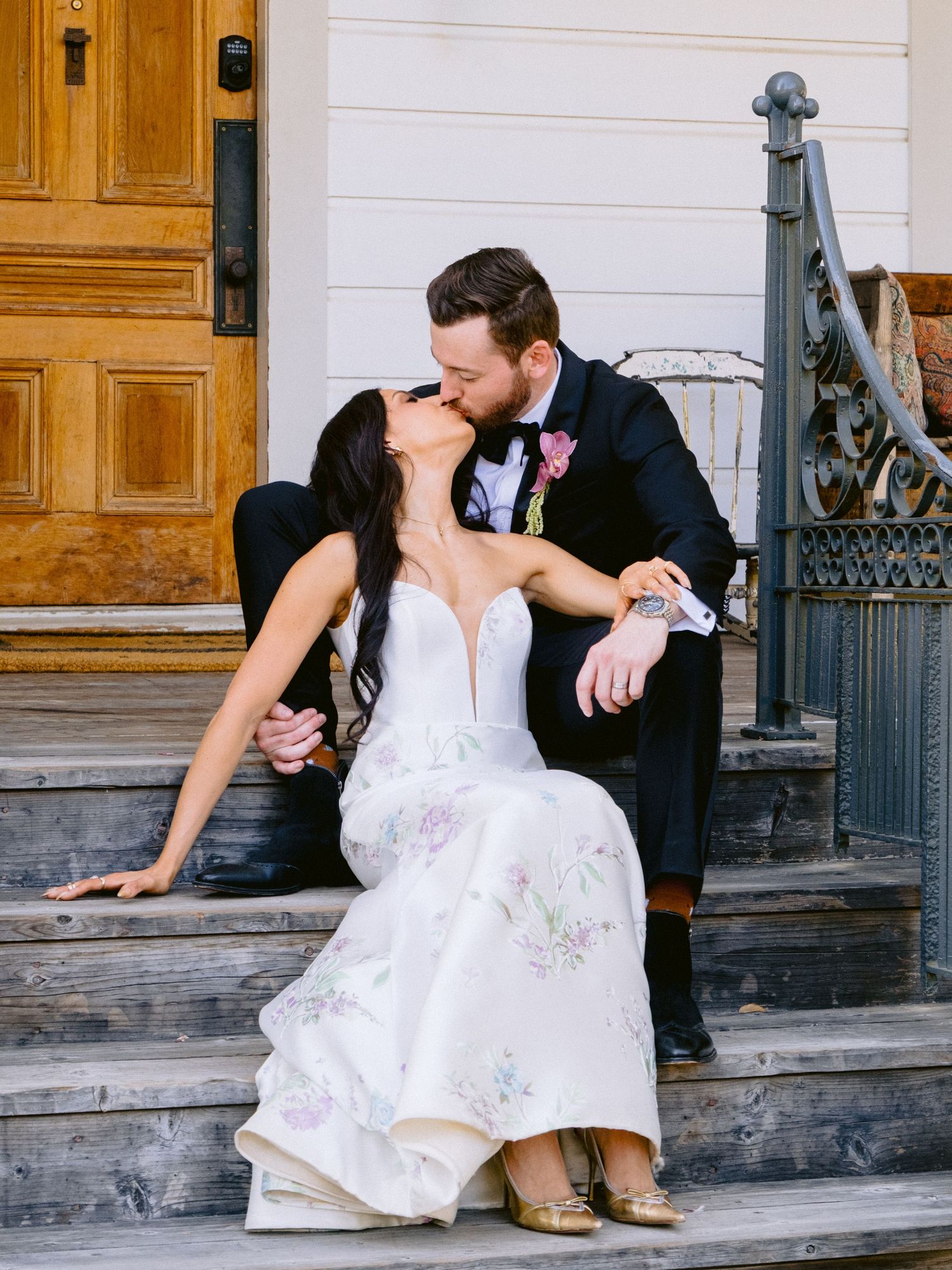 Candid wedding day moments captured on vintage wooden porch steps.