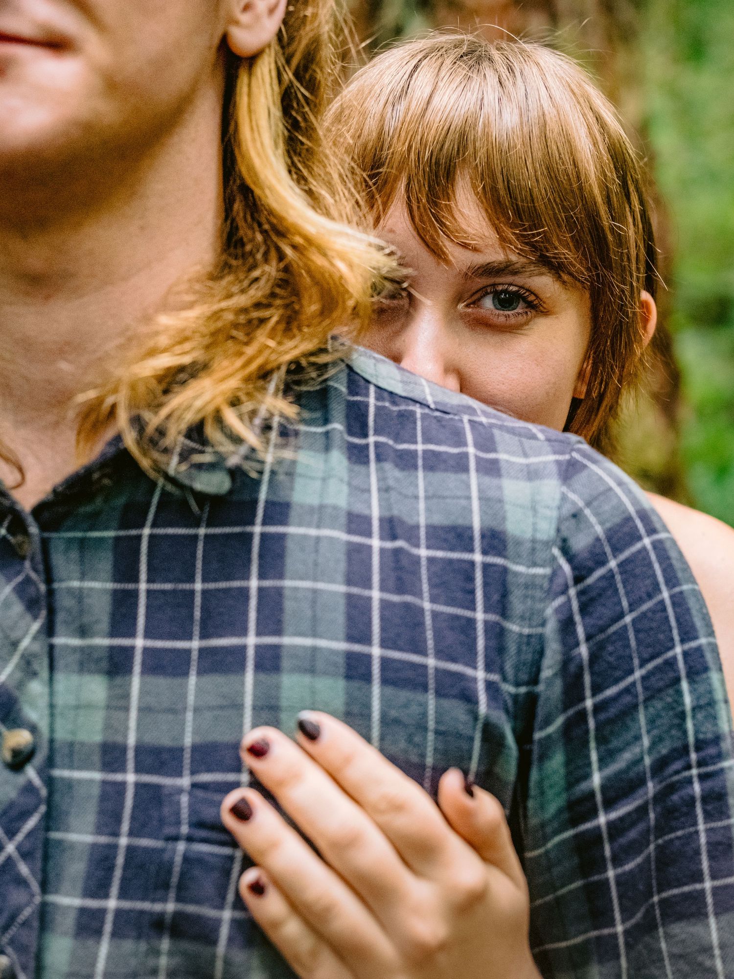 Close-up sequence showing details of plaid fabric and gentle hand gestures.