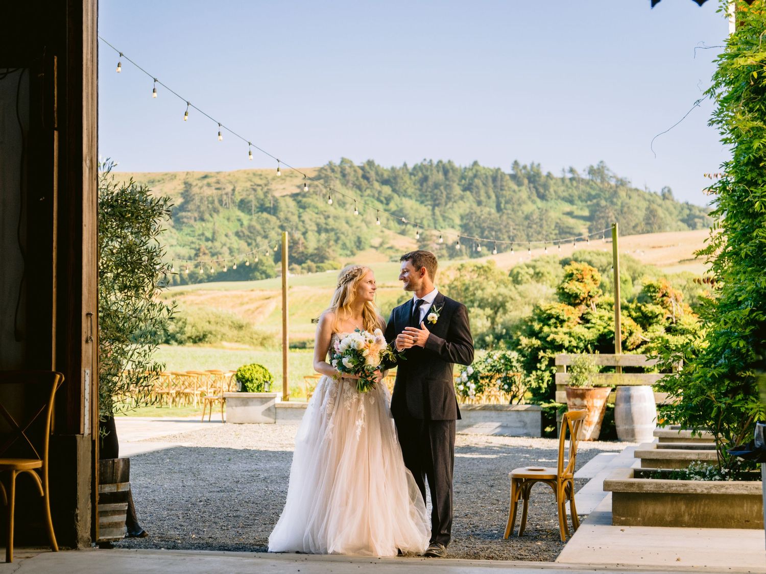 Outdoor wedding ceremony setup with mountain views and natural landscape in the background.