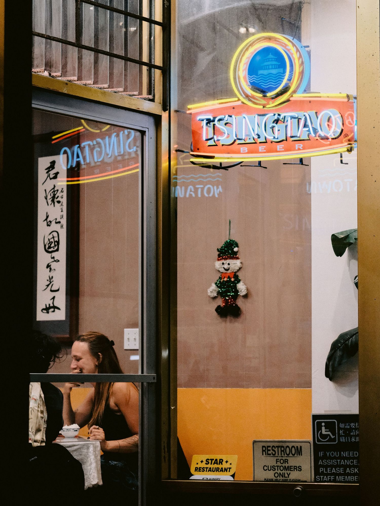 Interior shots of an Asian restaurant with neon signs and traditional decorations.