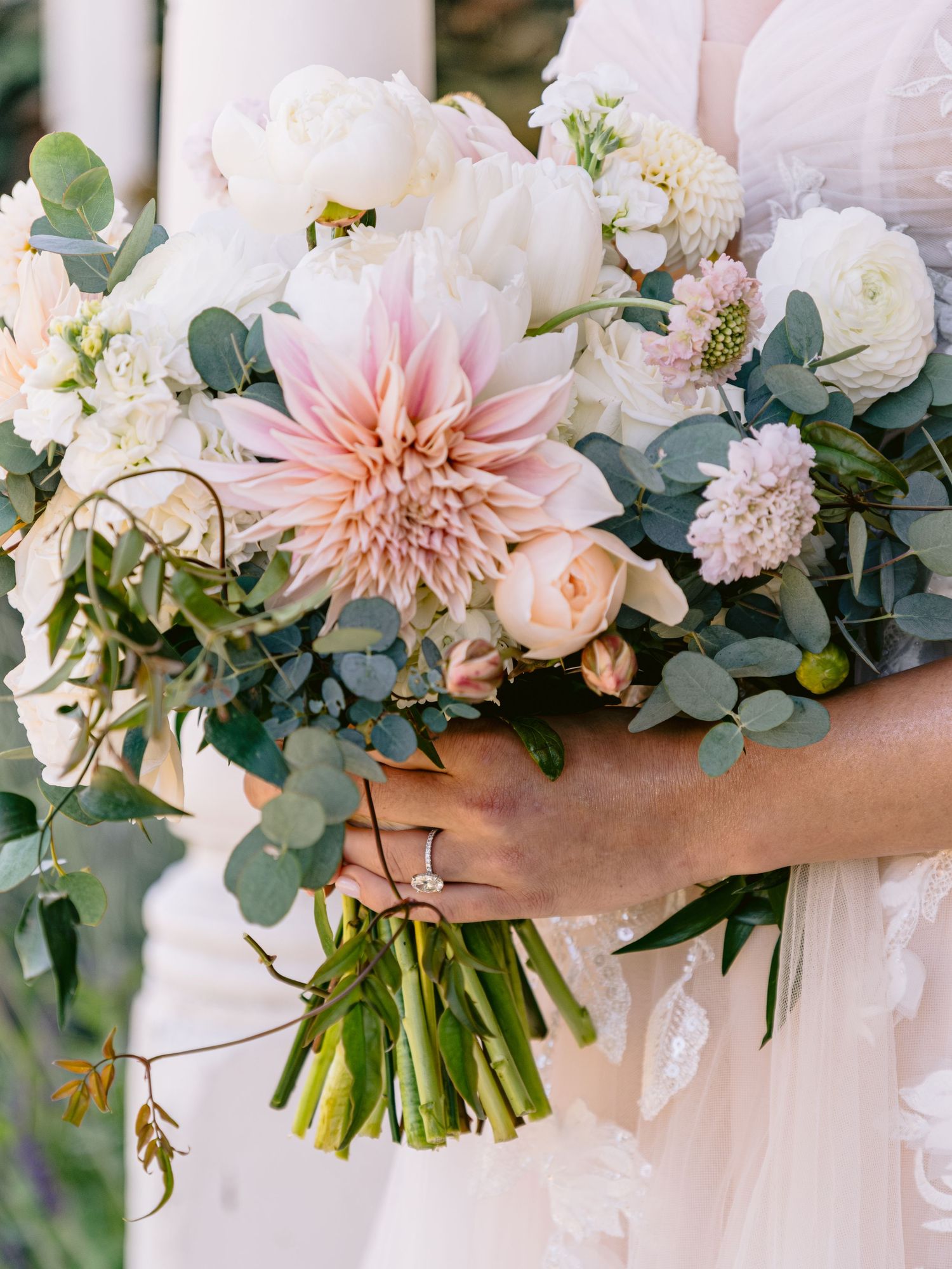 Romantic bridal bouquet with blush dahlias, roses, and eucalyptus greenery.