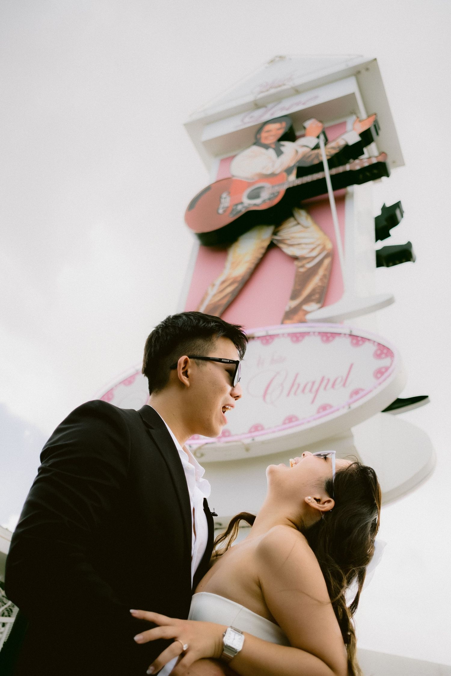 A romantic photo sequence showing a couple embracing under a pink chapel sign.