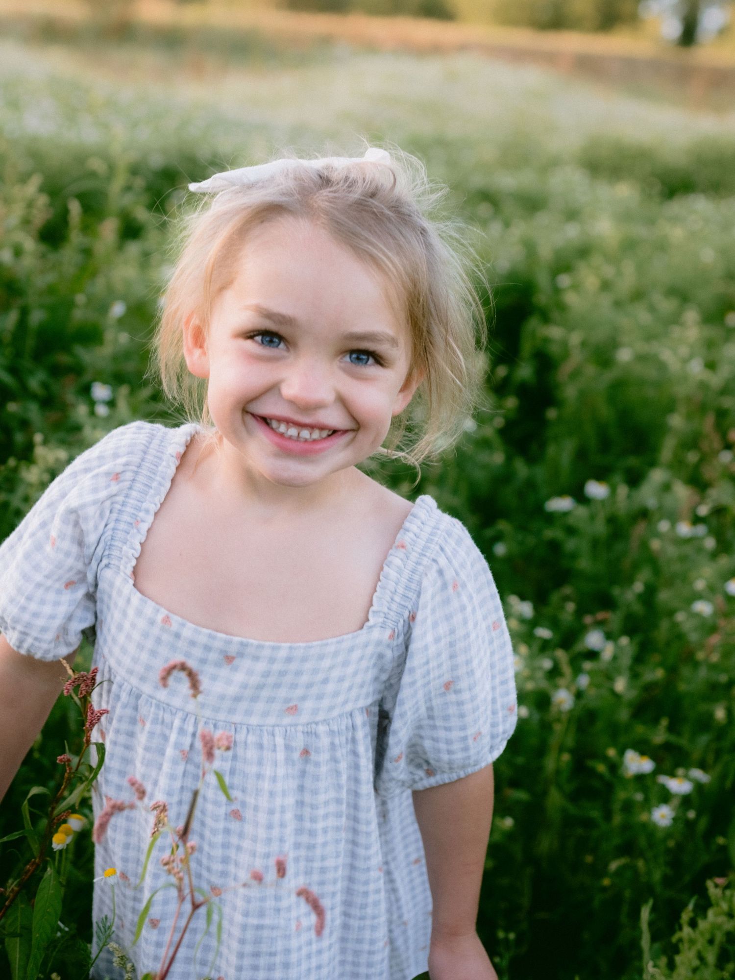 A sequence of joyful expressions in a field of wildflowers.