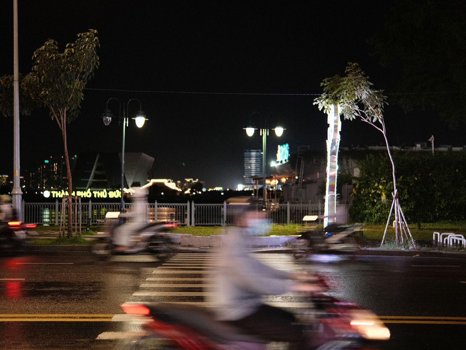 Long exposure night shots showing motion trails of vehicles on a dark road.