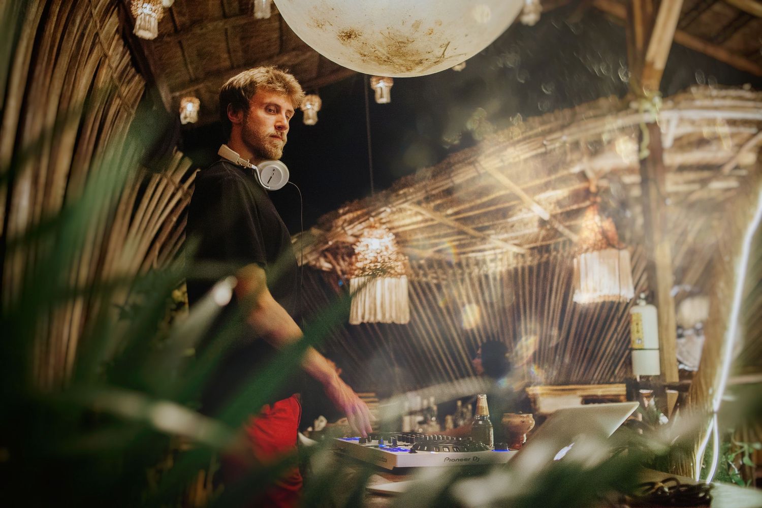 Mezcal pairing night in Tulum Downtown. DJ ignites the boho party vibe under twinkling lights and tropical energy.