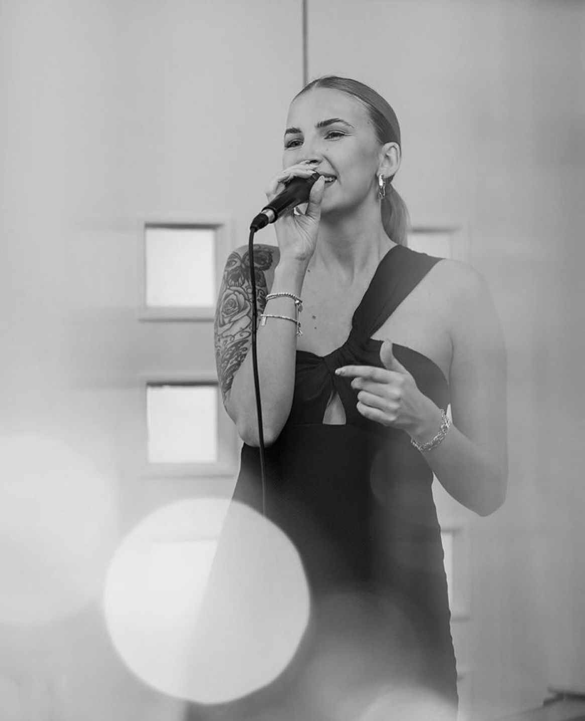 Black and white sequence of someone blowing up a balloon in four progressive stages against a light background.