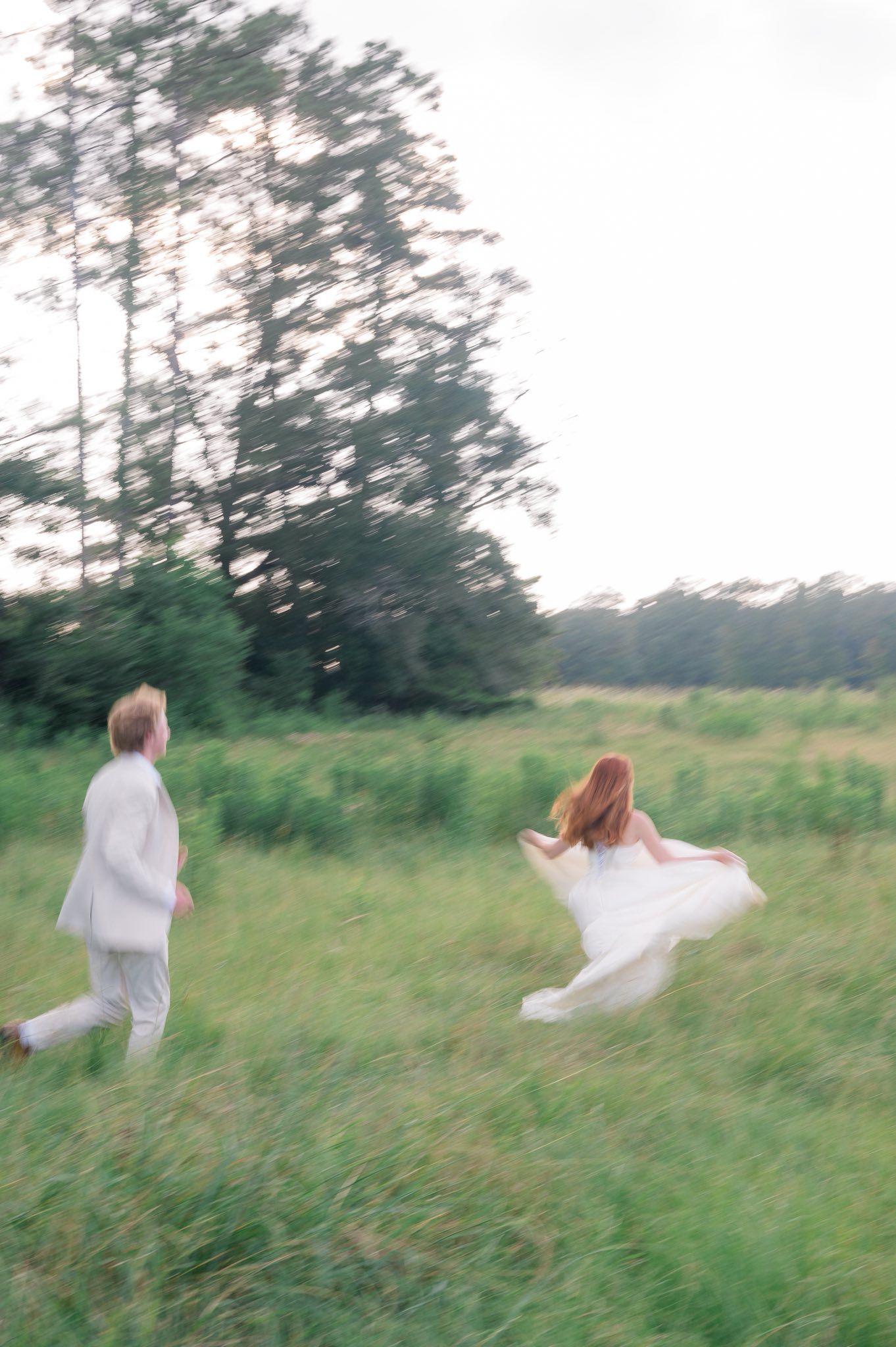 A series of ethereal photos showing figures in white clothing moving gracefully through a misty green meadow at dusk.