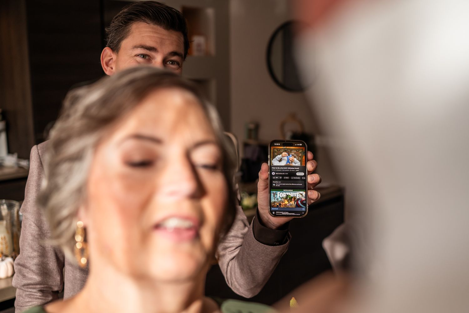 Close-up shot of someone holding a small jar during wedding preparations.