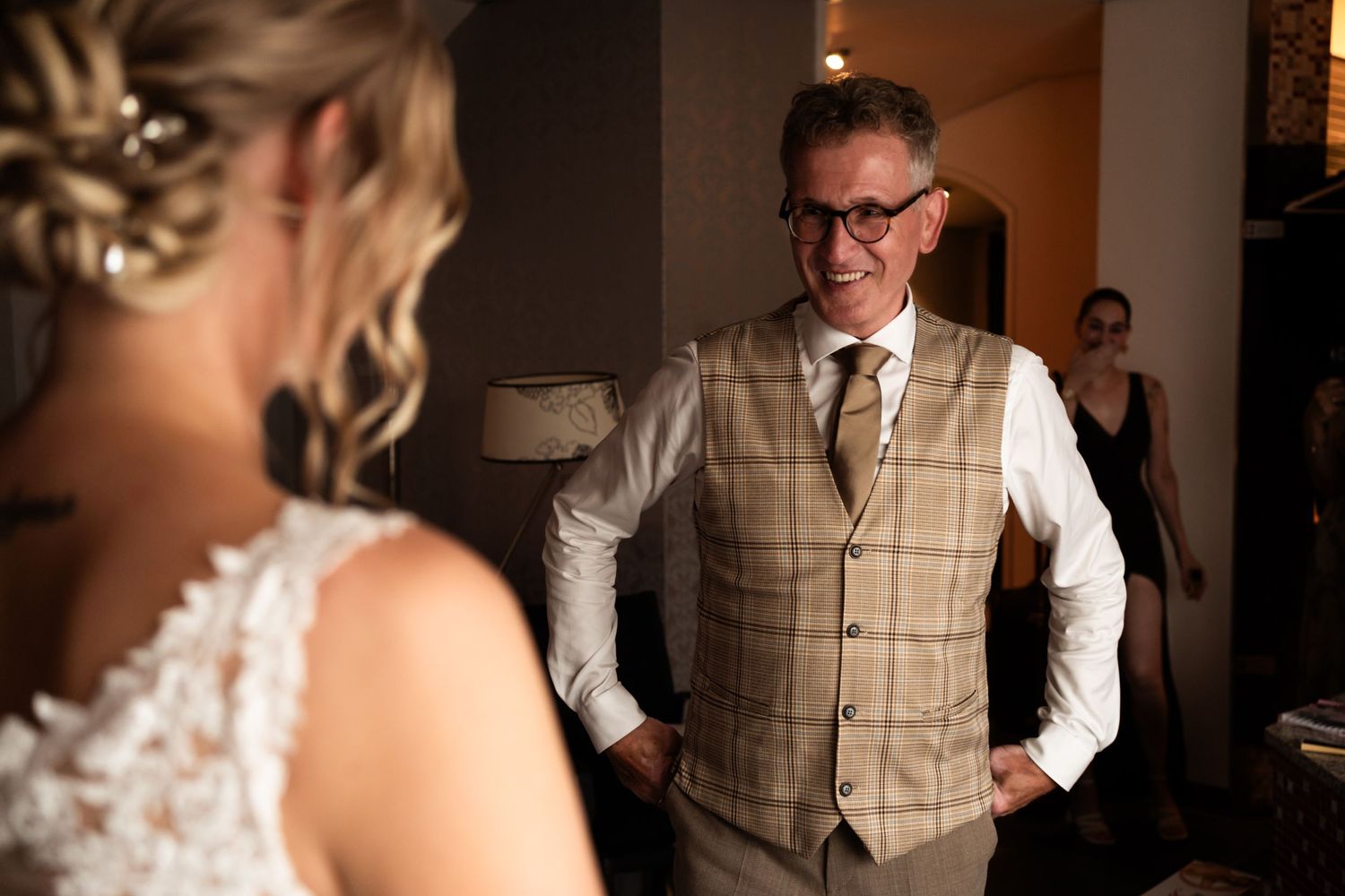 Emotional moment captured as groom sees bride in her wedding dress for the first time.