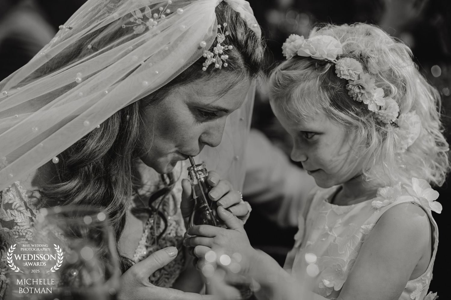 Sweet black and white moment shared between two in delicate lace and veils.