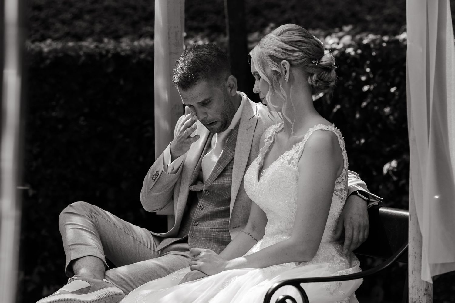 Intimate black and white photo of a couple sharing an emotional moment during their wedding.