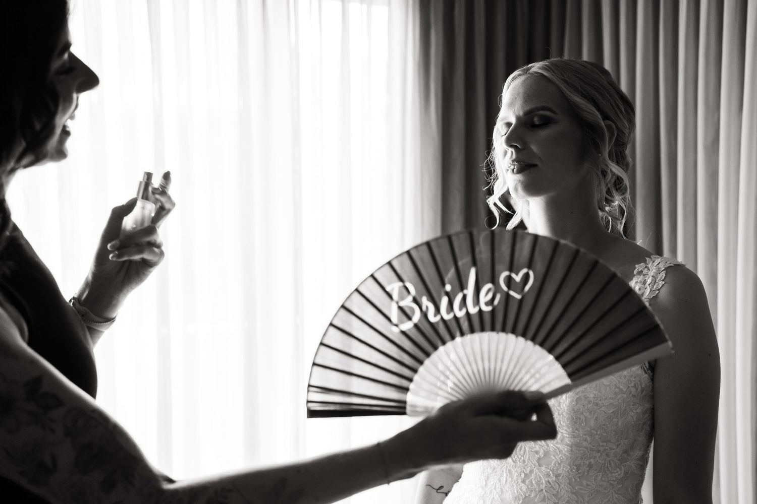 A black and white photo shows a person holding a decorative fan labeled 'Bride' during preparations.
