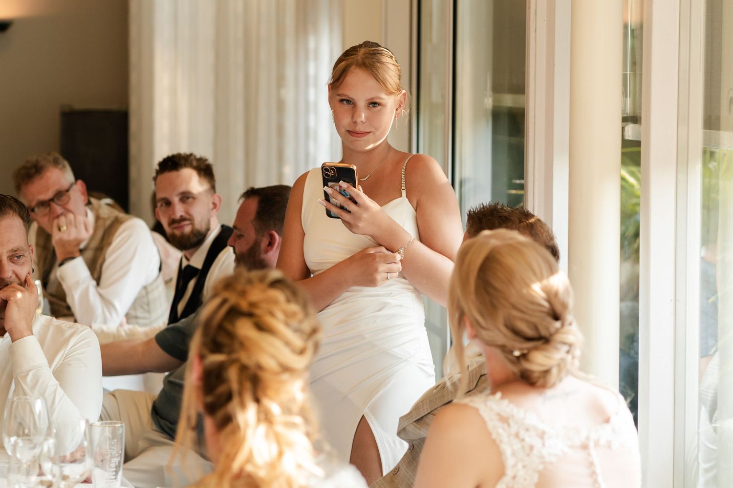 Wedding reception speech being delivered in an elegant indoor venue.